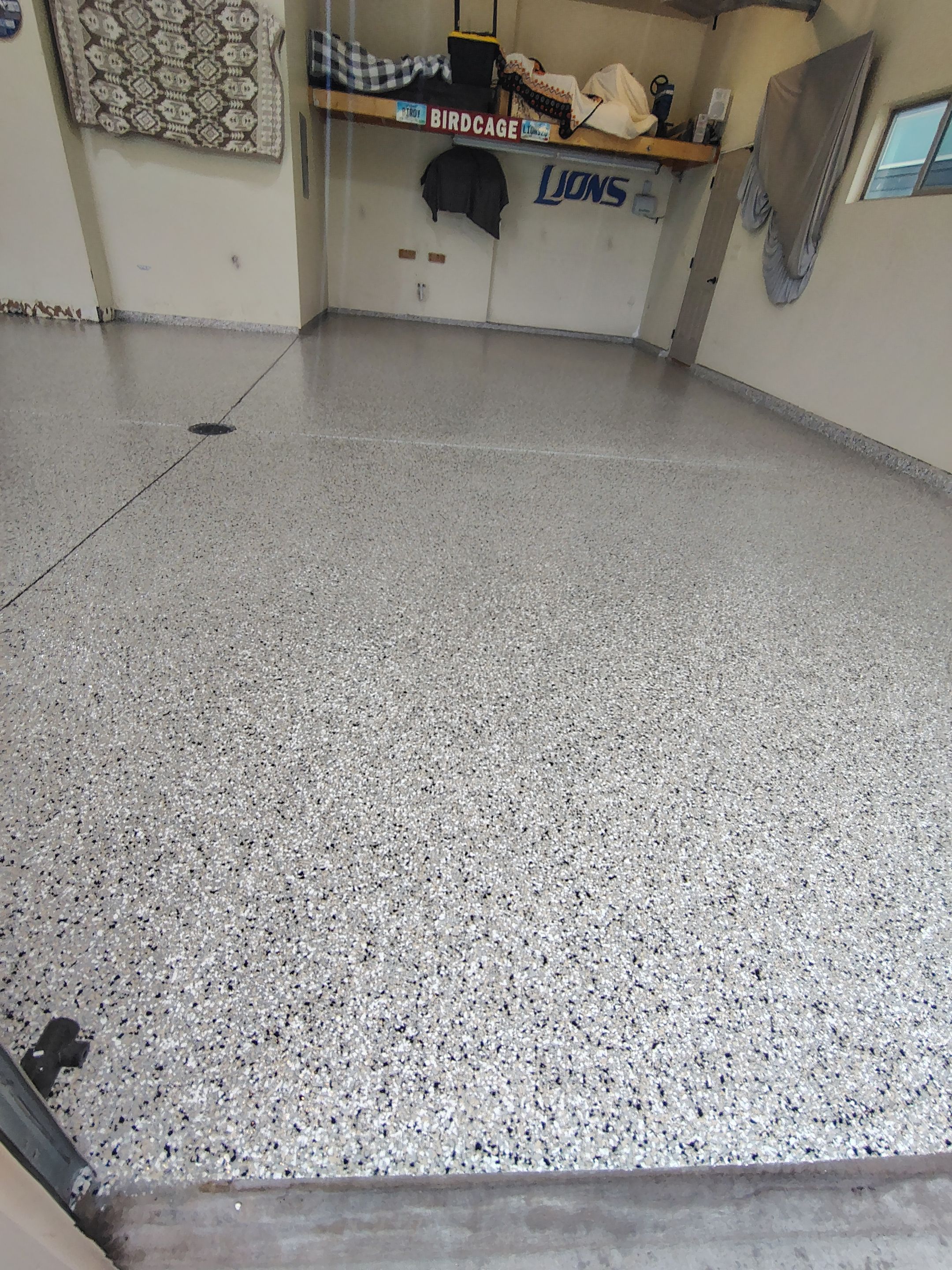 Sioux Falls Garage Floor Repair and Speckled Epoxy Coating Installation by Select Painting, Coatings & Garage Cabinets