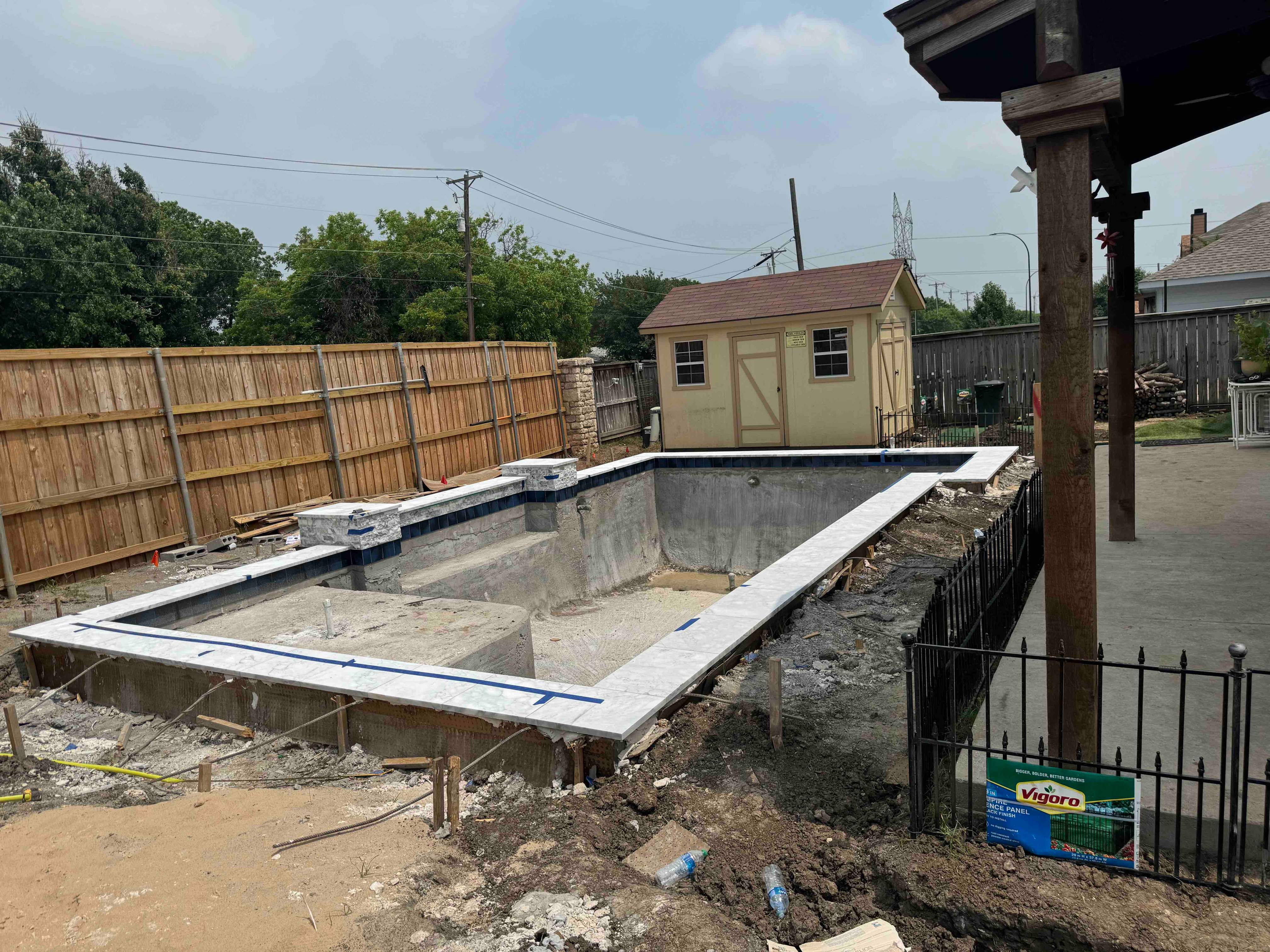 Geometric Pool with Raised Stone Accent Wall by Pinnacle Pools and Spas - DFW