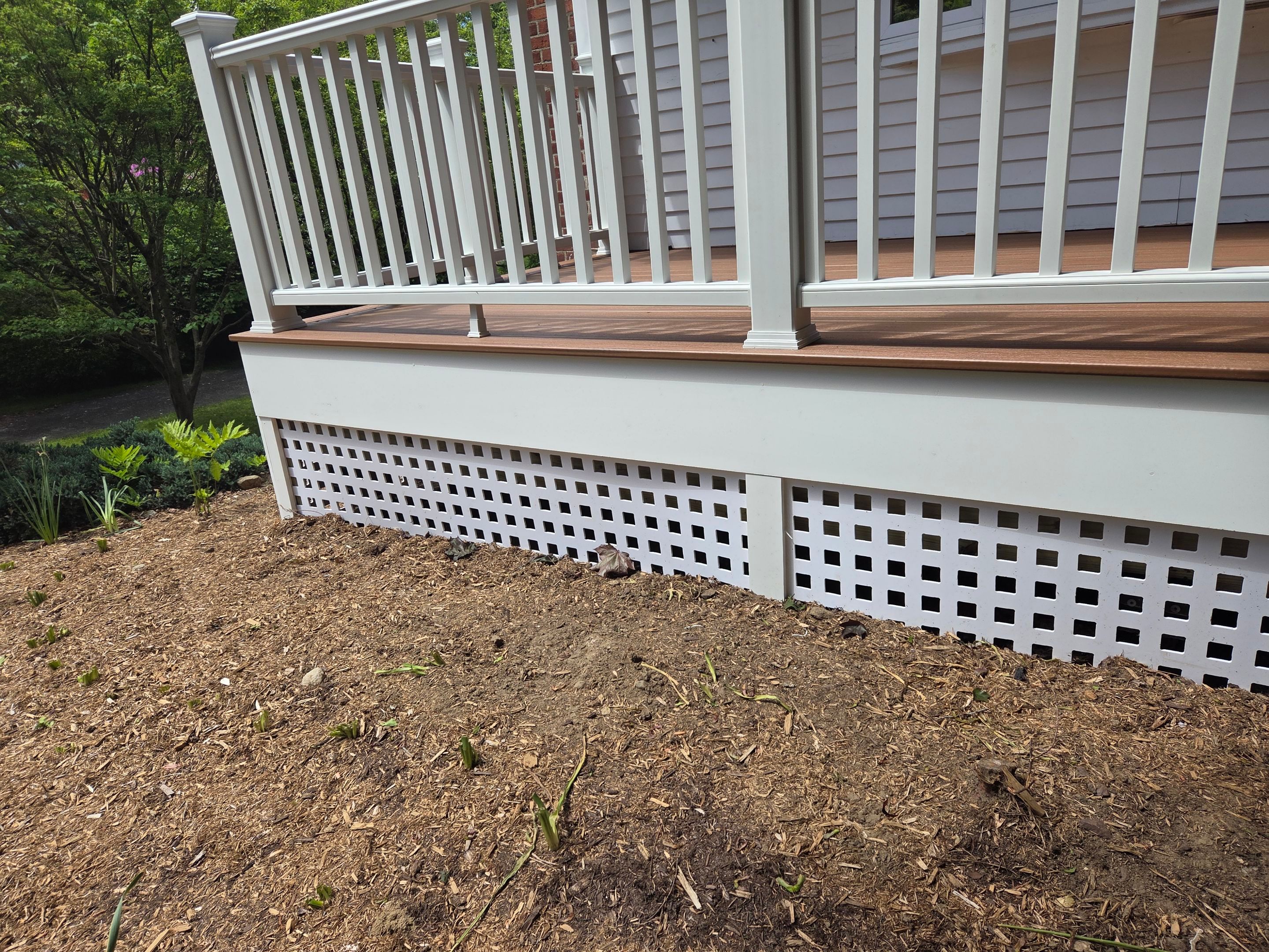Deck Replacement, Trex Tiki torch boards, with White composite railing and lattice. by DiGiorgi Roofing and Siding Inc
