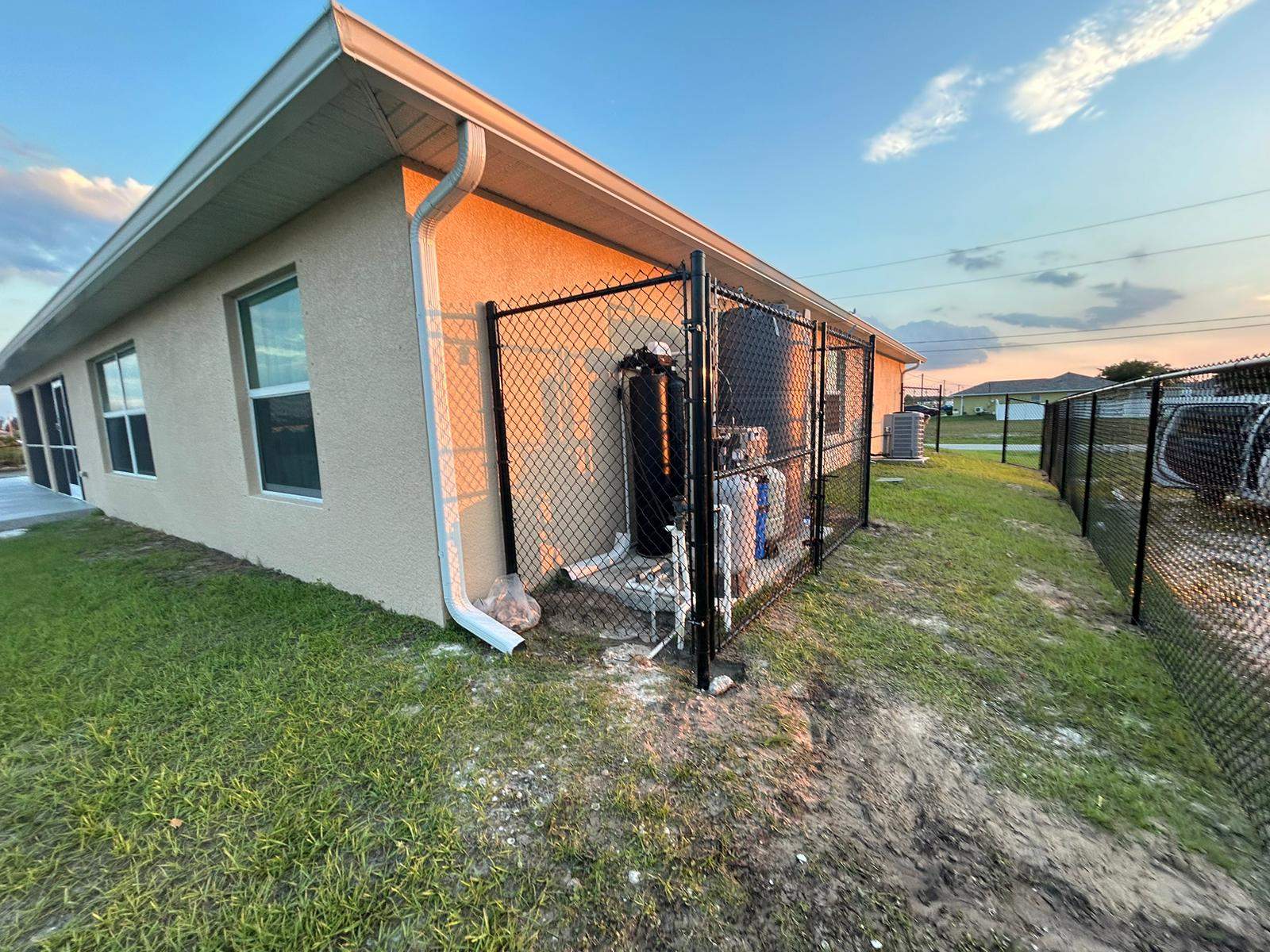 Black Chain Link Perimeter Fence and Utility Enclosure in Cape Coral by True Fence LLC
