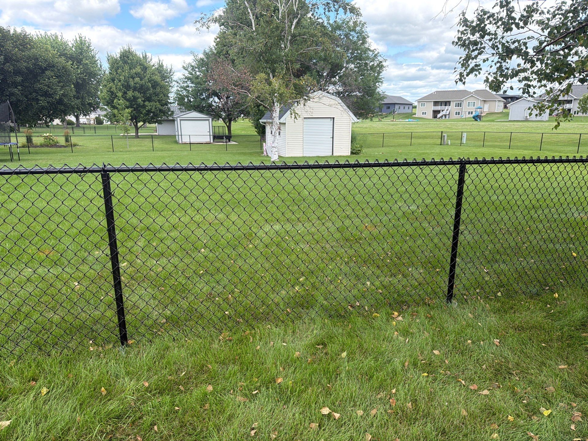 Black Vinyl-Coated Chain Link Fence Installation in Fairbank by Perfect Picket Fence and Stain