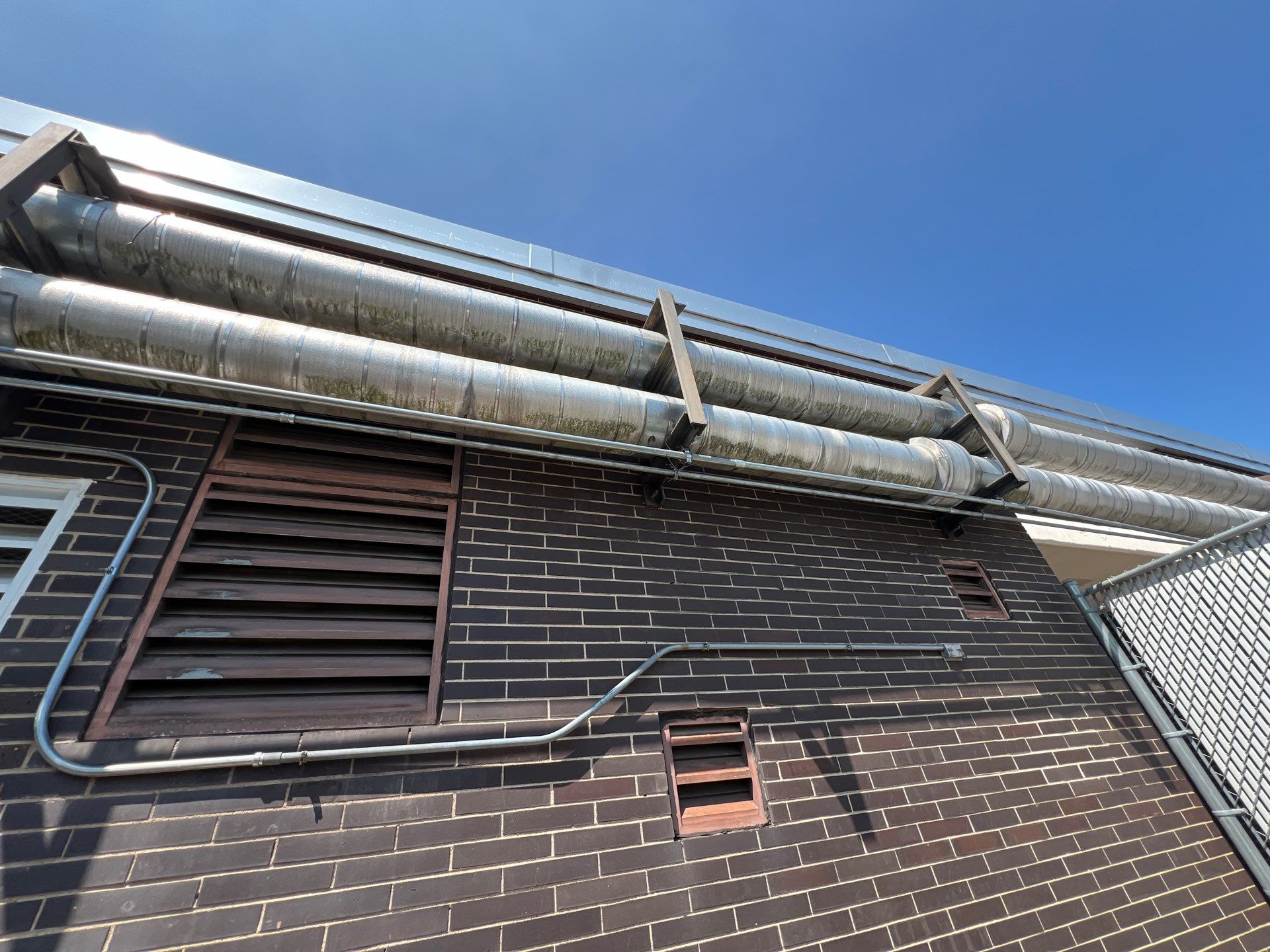 commercial pressure washing using Algaecide, soft wash soap by Northern Power Washing LLC.
