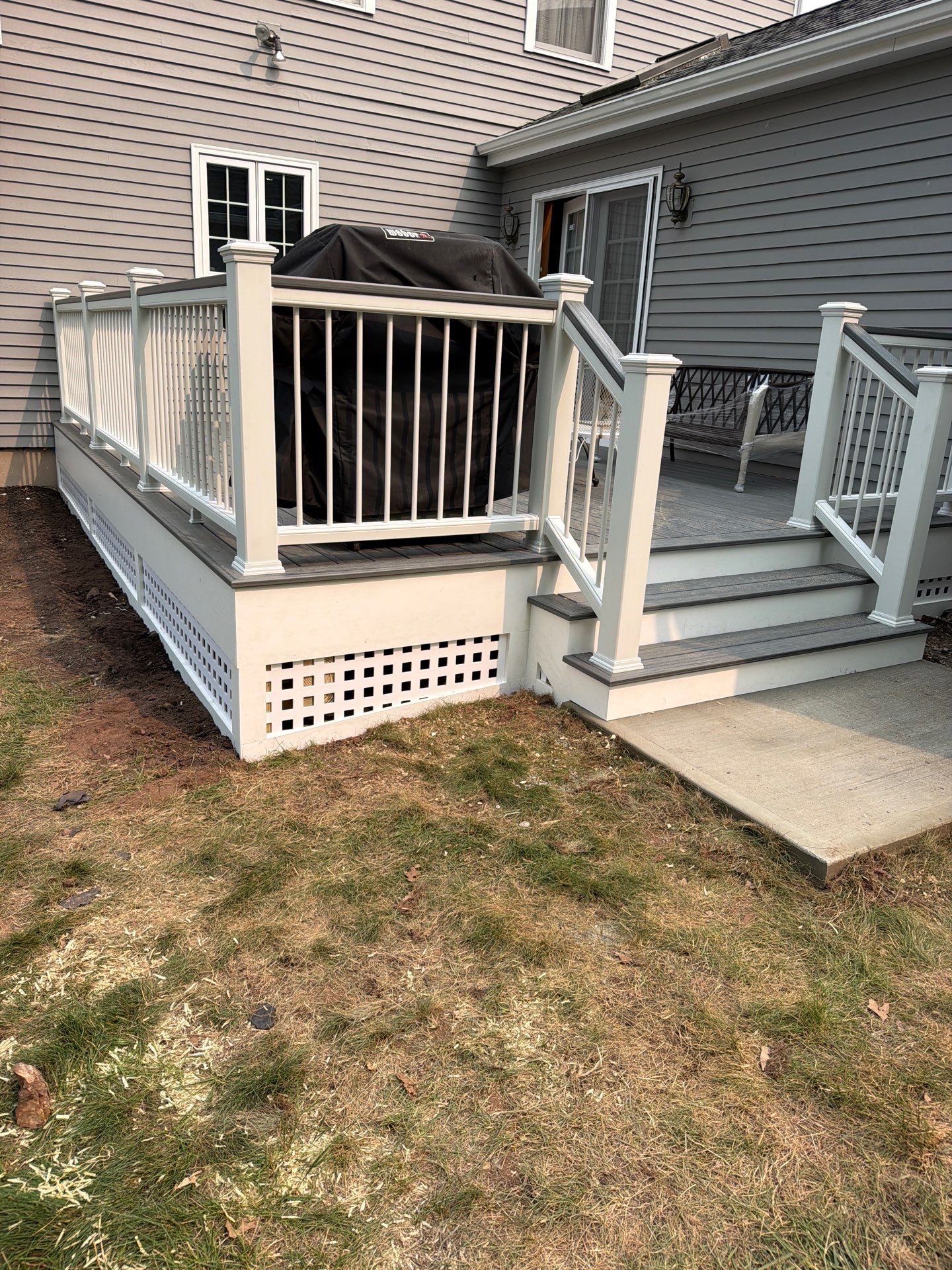 Replacement deck using Trex Tropical Island mist decking and matching cocktail railing. Enclosed with Lattice by DiGiorgi Roofing and Siding Inc