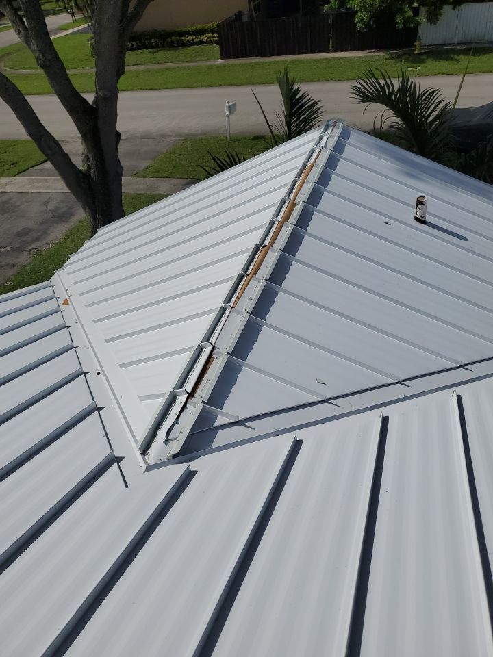 Residential Roofing Installation using 1.5" Nail Strip 24ga Solar White Kynar Coated Standing Seam Metal Panels by Morton Roofing, Inc.