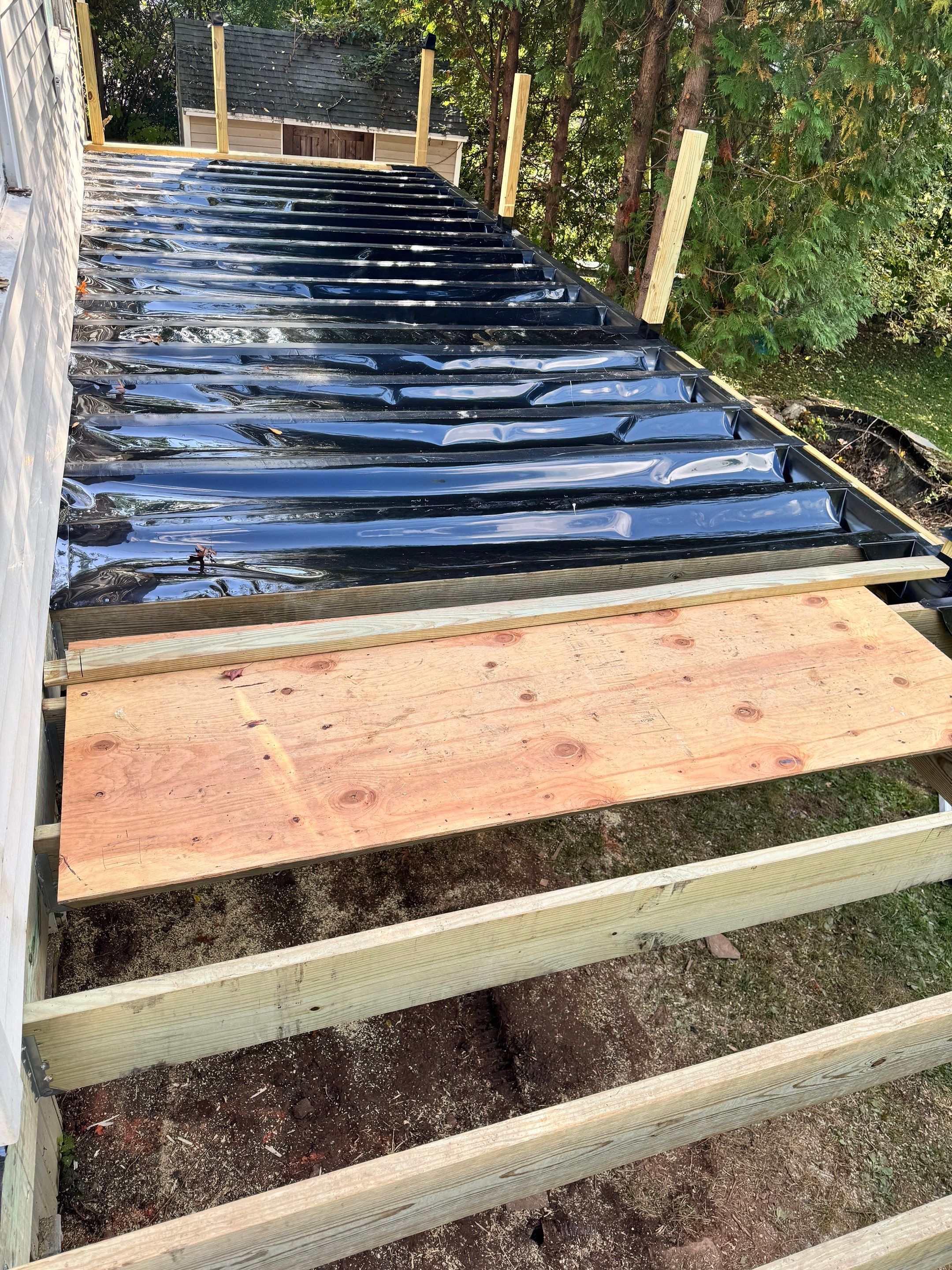 New Deck, Trex Select Pebble Gray boards, Composite railings in white, Trex Rainescape system, and gate. by DiGiorgi Roofing and Siding Inc