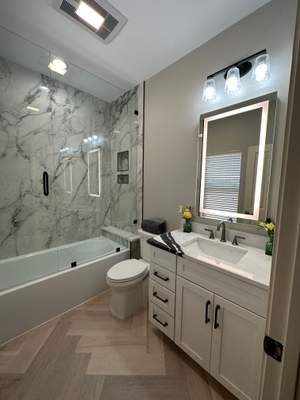 Boerne Guest Bathroom Remodel with Marble Tub Surround & Herringbone Flooring
