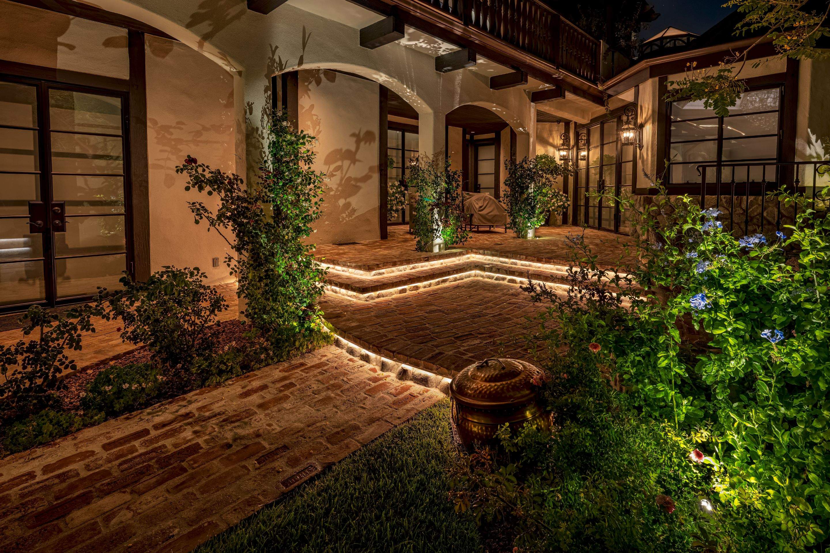 Tudor Estate Landscape Lighting with Integrated Stone Step Illumination by Outdoor Lights + Shades