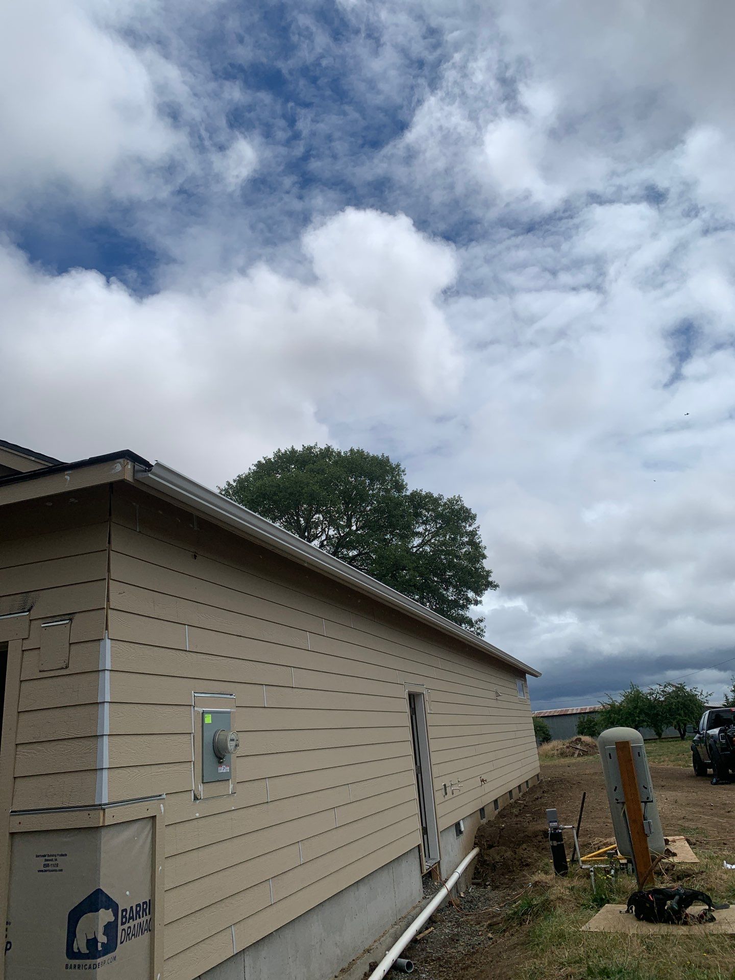 Seamless White Gutter Installation for Eugene New Construction Home by BEST Roofing & Waterproofing