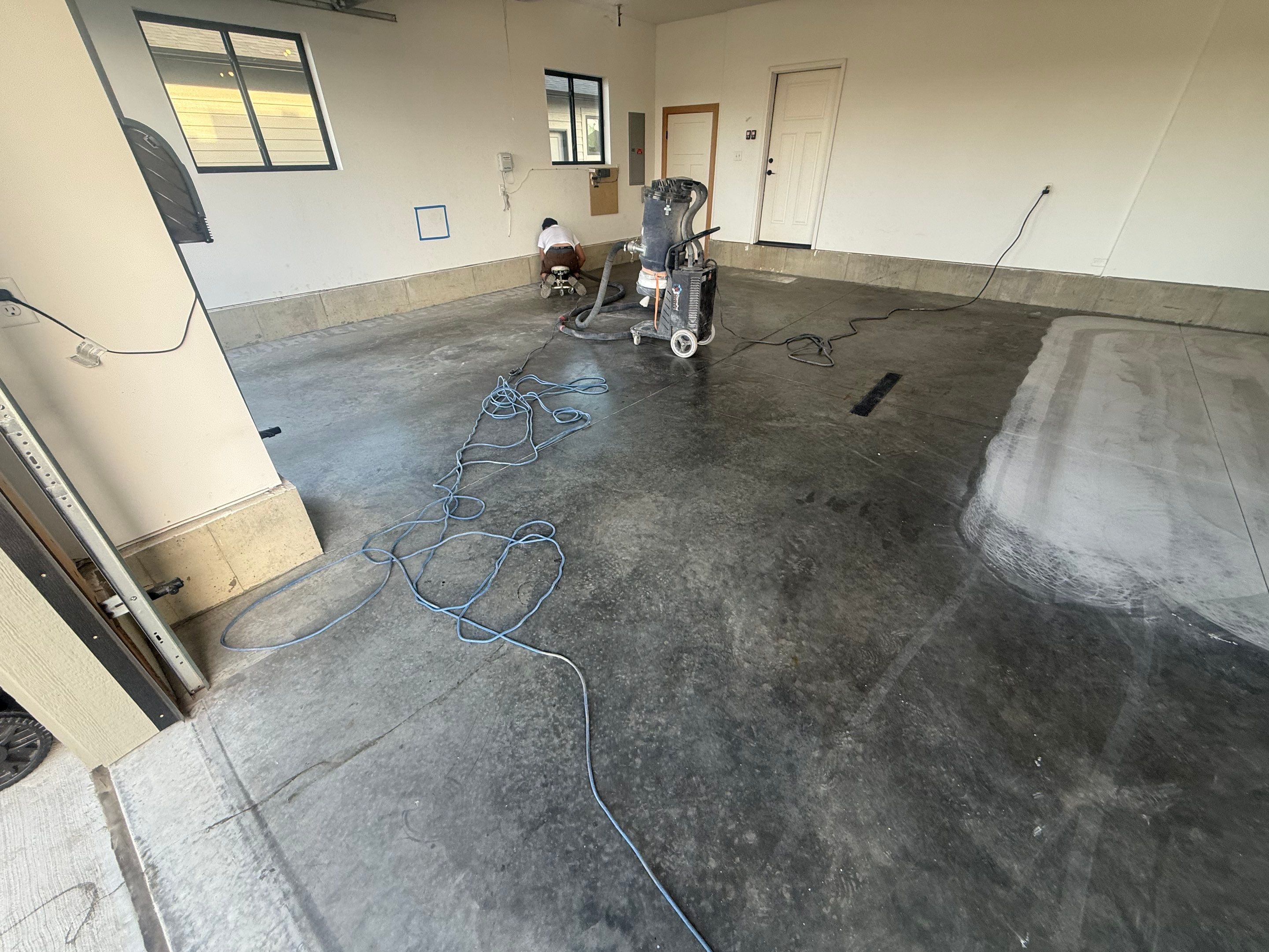 Full Garage Concrete Coating with Grey Speckled Epoxy in Brandon by Select Painting, Coatings & Garage Cabinets