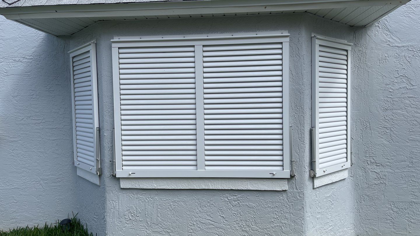 Accordion shutter and Bahama with front slide rod by Smart Guard Shutters