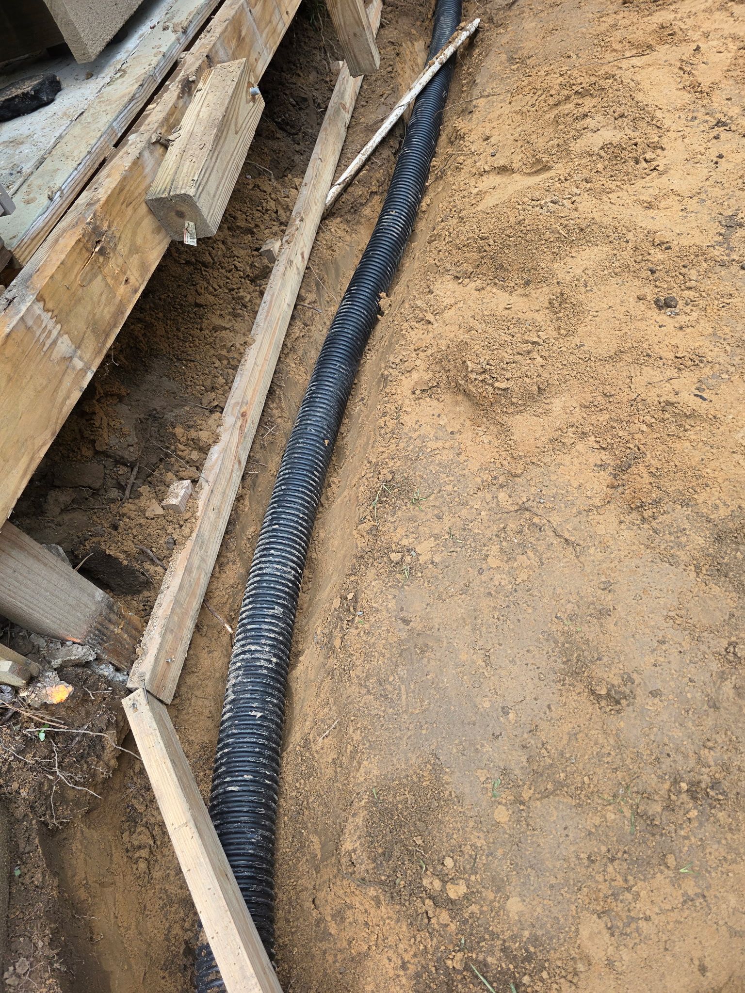 Patio in concrete with drainage improvements by Cornerstone Home Builders, LLC