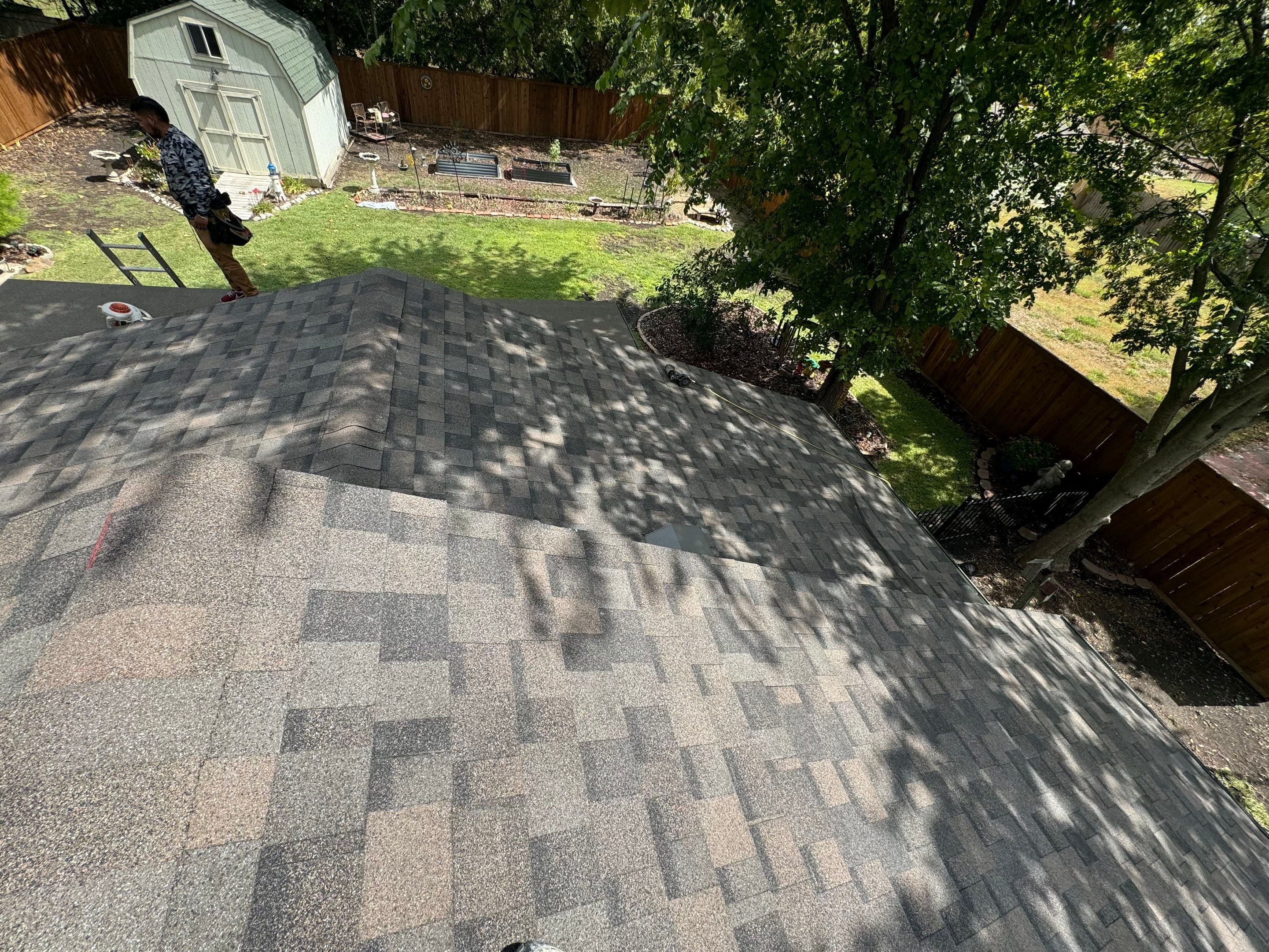 IKO Driftshake-Dark green siding house by Tejas Roofworks + Restoration