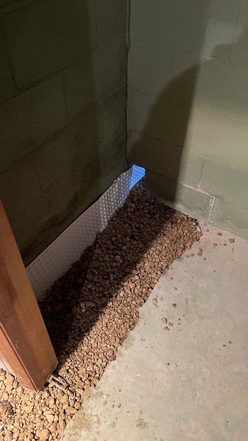 Interior drain tile system installation by ACE Waterproofing & Basement Solutions