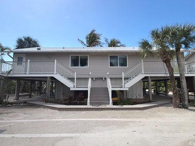 Elevated Coastal Home Renovation with Siding and Custom Decks in Englewood by Smirnov Construction Inc