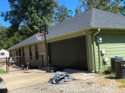 Exterior Repaint – Tyler, Texas - Bold green color with black garage