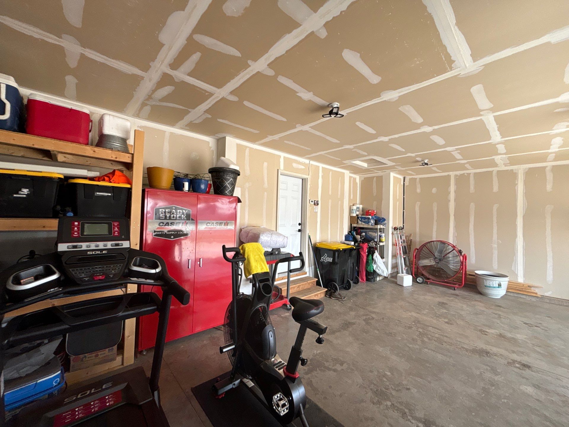 Grey Flake Epoxy Garage Floor Coating in Sioux Falls by Select Painting, Coatings & Garage Cabinets