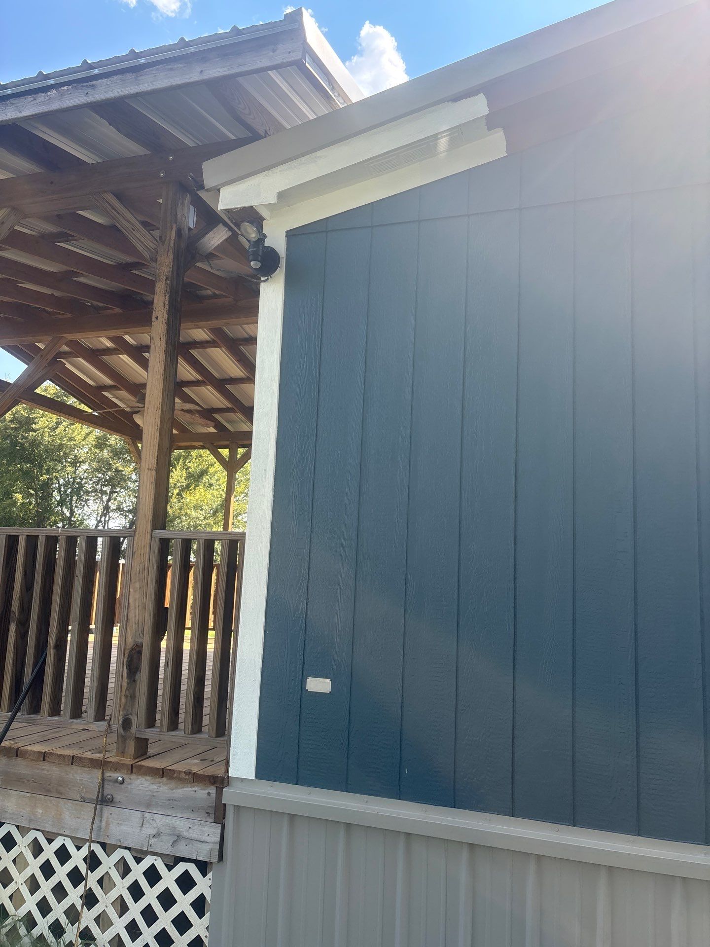 Exterior Painting in Fruitvale, TX | Wood Porch & Home in Deep Navy Blue by Quality Coats Painting