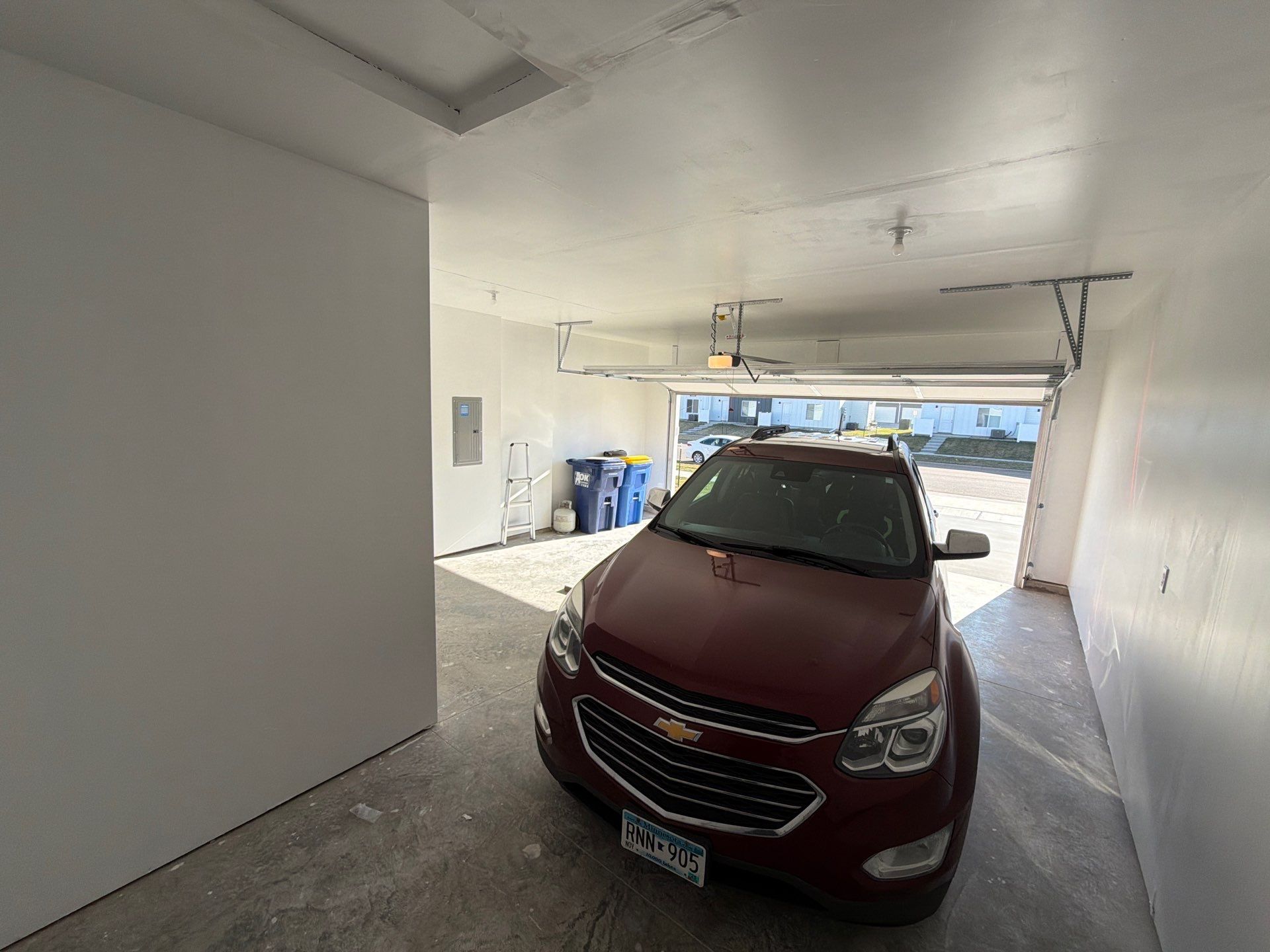 Sioux Falls Garage Floor Transformation with Cabin Fever Decorative Chips by Select Painting, Coatings & Garage Cabinets