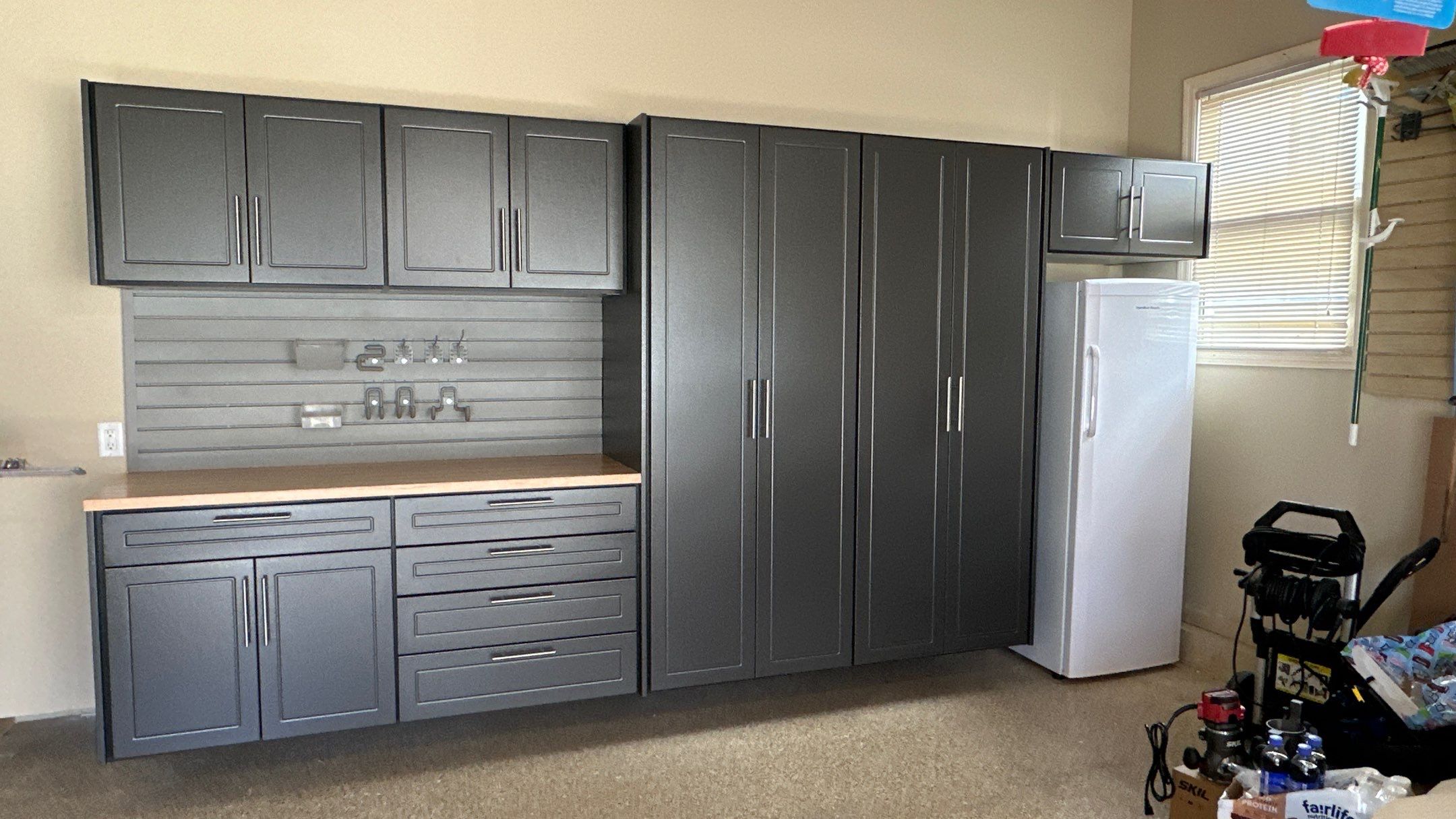 Trevor F. got a workbench with his garage cabinets.  by Banner Garage