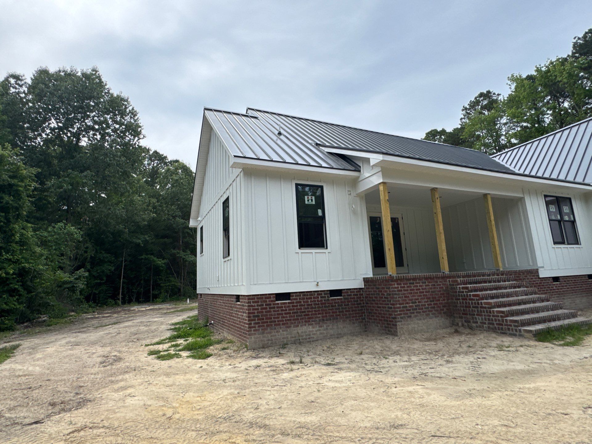 Custom New Construction Home Featuring Standing Seam Metal Roofing in Port Haywood by Cade Construction