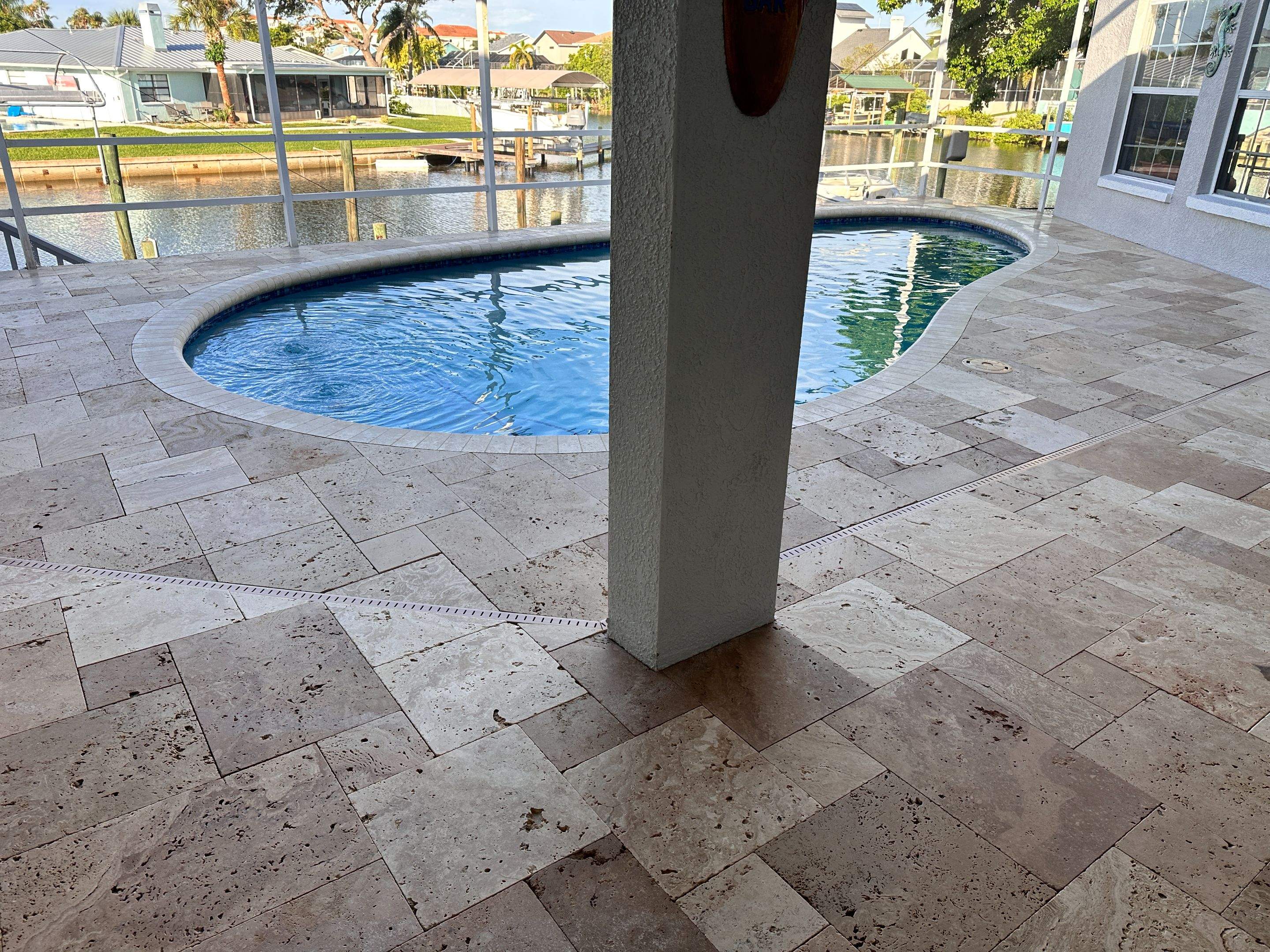 Travertine Sealing and Stripping for a Waterfront Pool Deck in Apollo Beach by Supreme Paver Experts
