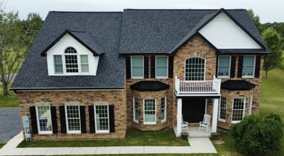 Roof Damage using Certainteed Lifetime Roofing System- Moire Black Landmark Pro shingkes with shadow ridge caps.