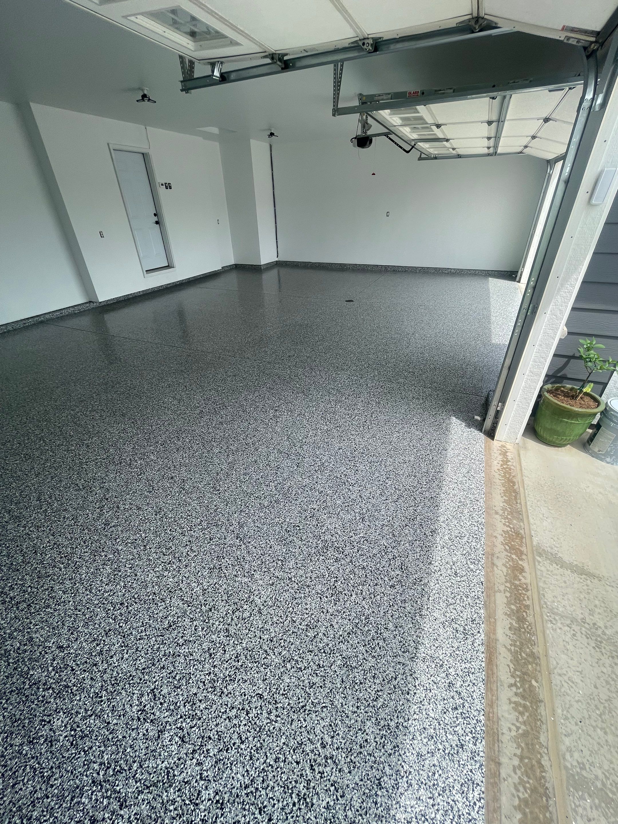 Grey Flake Epoxy Garage Floor Coating in Sioux Falls by Select Painting, Coatings & Garage Cabinets