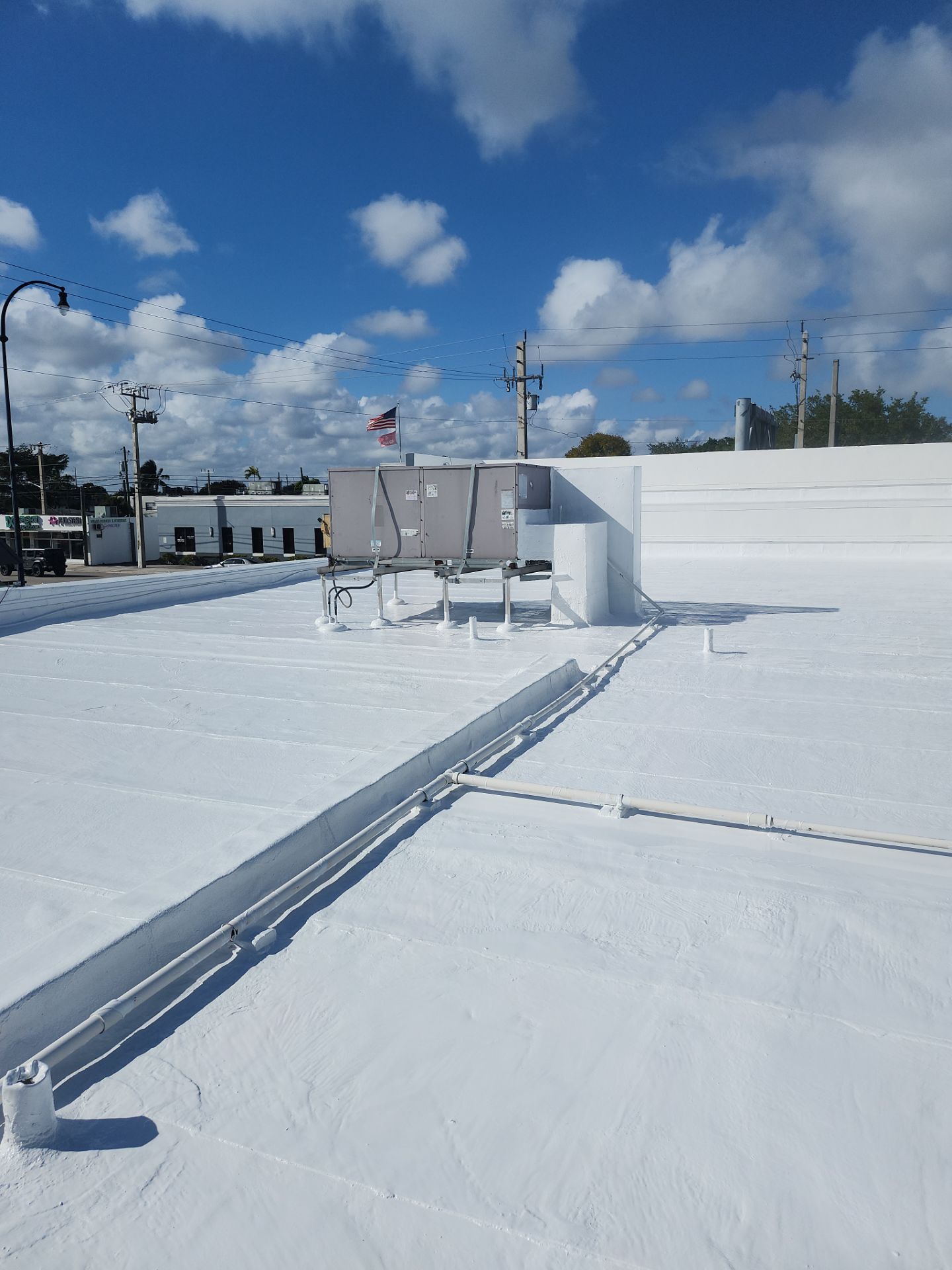 Commercial Flat Roof Restoration Using Silicone Coating in Hallandale Beach by Aastro Roofing