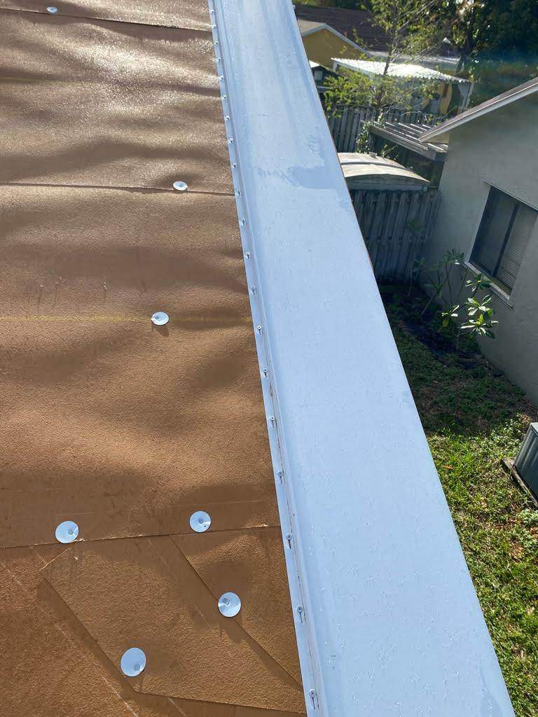 Standing Seam Metal & Flat Re-Roof using 1.5" Nail Strip 24ga Solar White Kynar Coated Standing Seam Metal Panels by Morton Roofing, Inc.