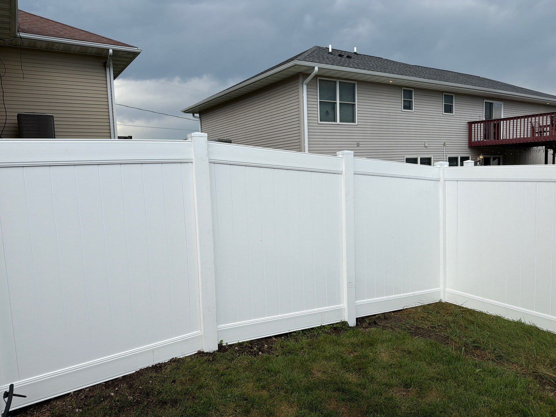 White Vinyl Privacy Fence Installation in Raymond, IA by Perfect Picket Fence and Stain