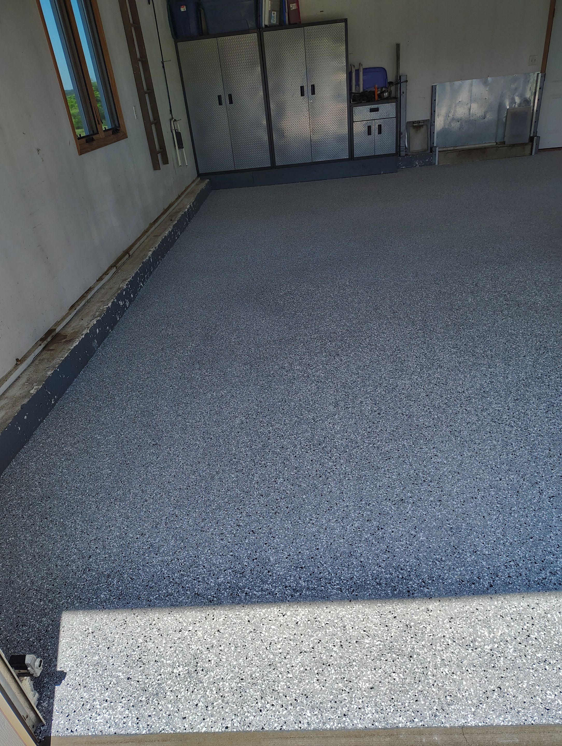 Feather Grey Garage Floor Coating Installation in Valley Springs by Select Painting, Coatings & Garage Cabinets