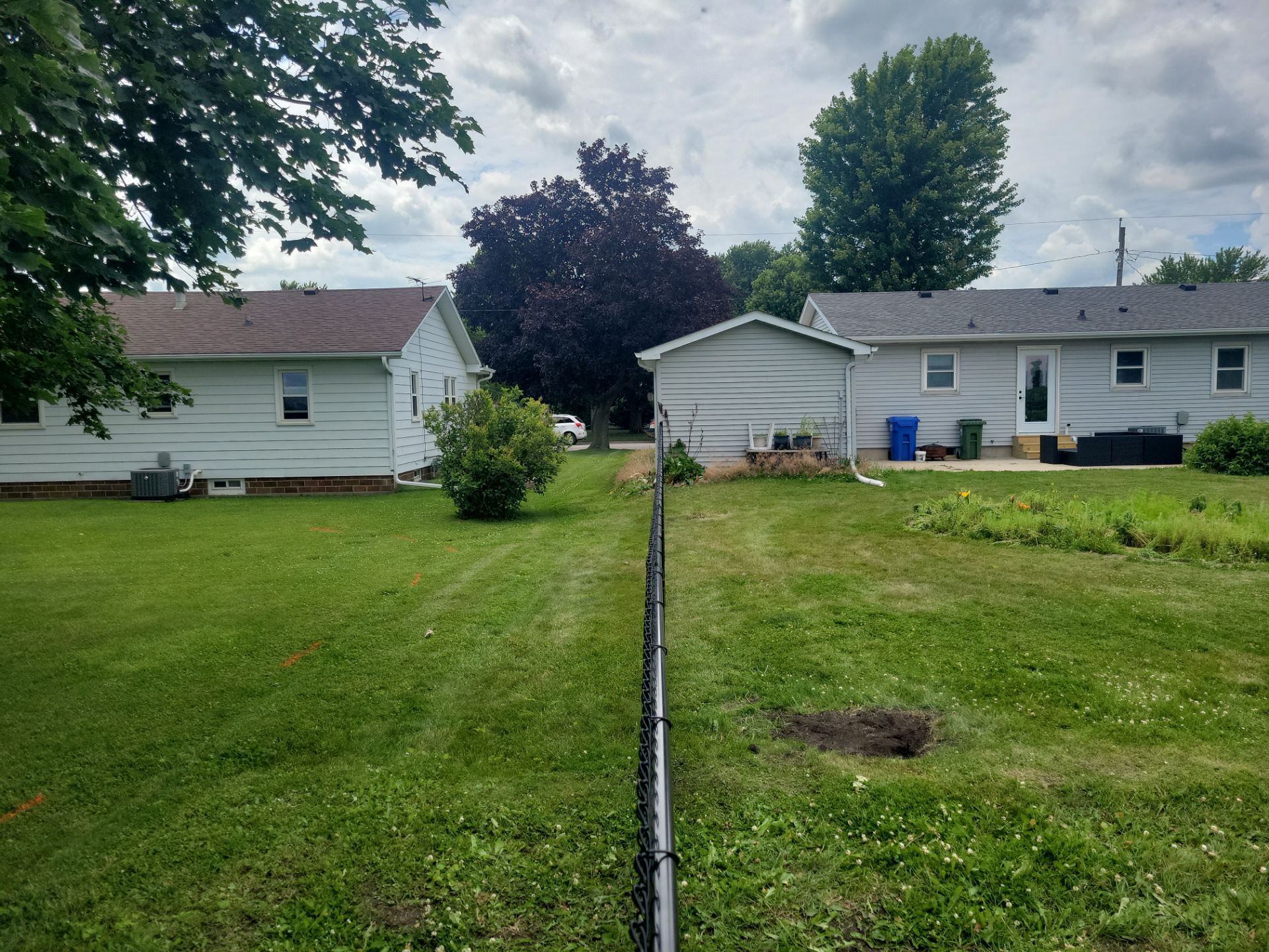 Residential Black Vinyl-Coated Chain Link Fence Installation in Allison by Perfect Picket Fence and Stain