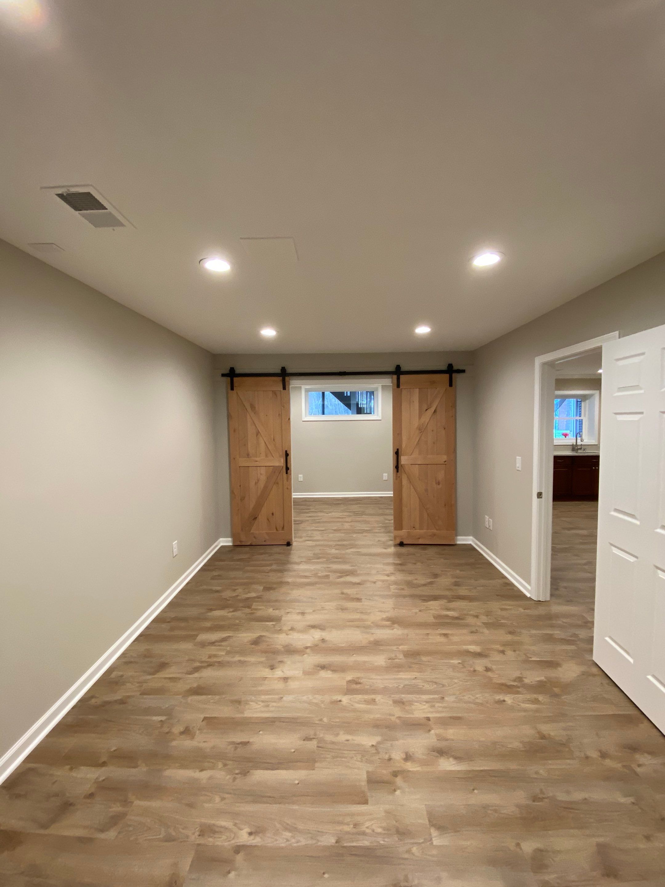 Acworth Basement Transformation With Wet Bar and Stone Fireplace by Swift Home Renovations