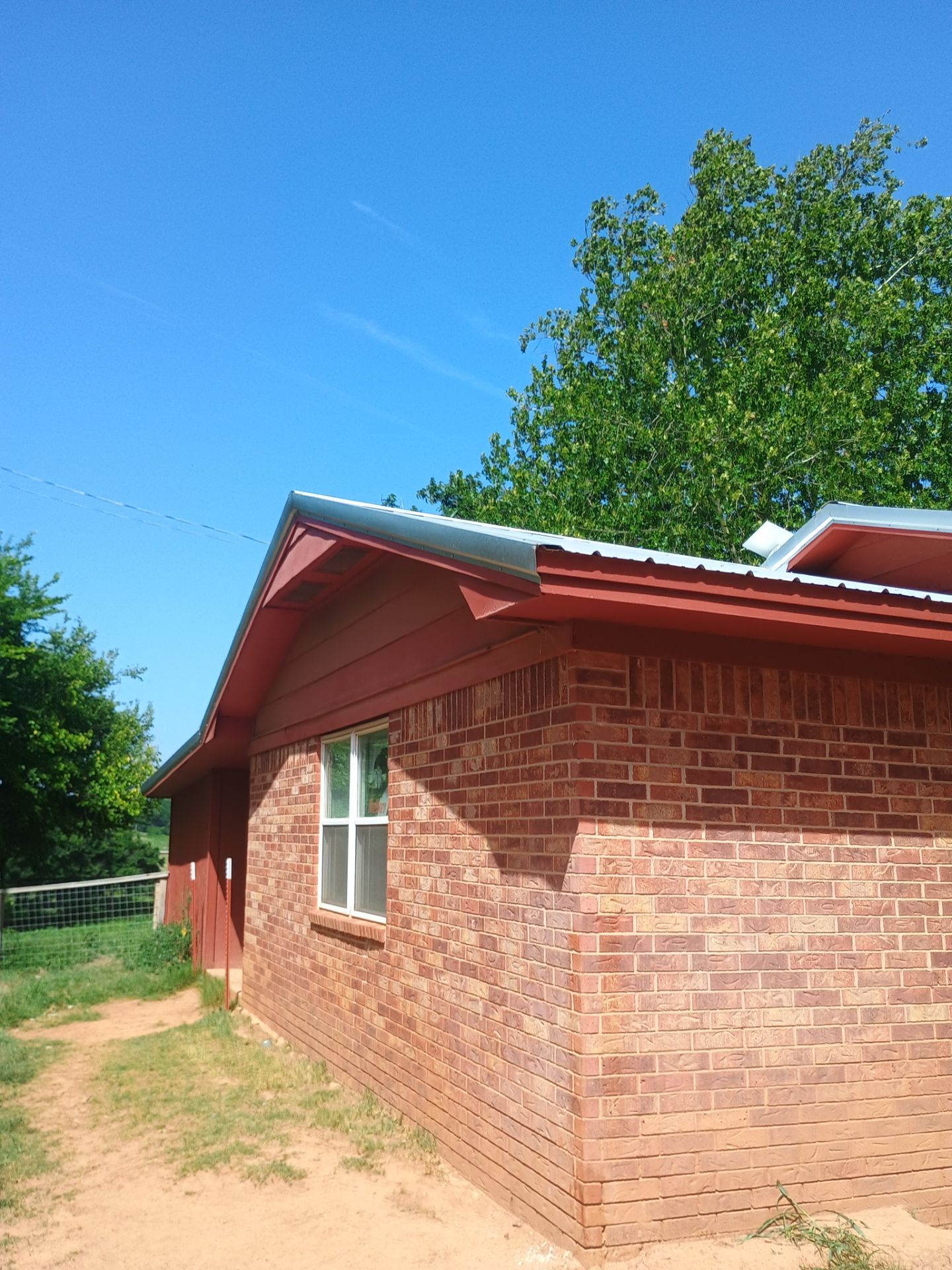 Corrugated Metal Roof Repair for Brick Home in Lindsay by BANA Roofing and Solar Supply