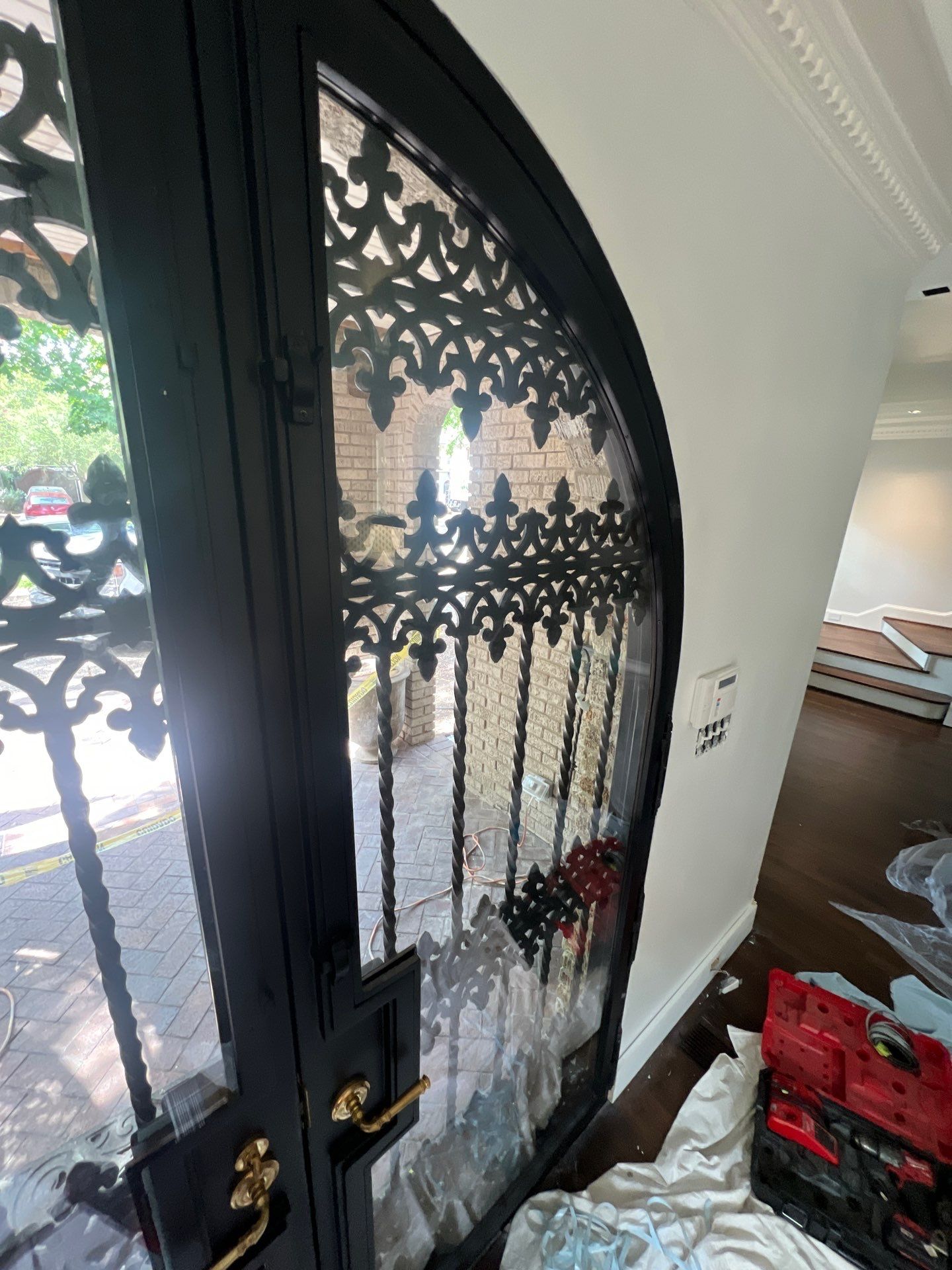 Custom Arched Black Wrought Iron Double Door Installation in Dallas by Solara Custom Living