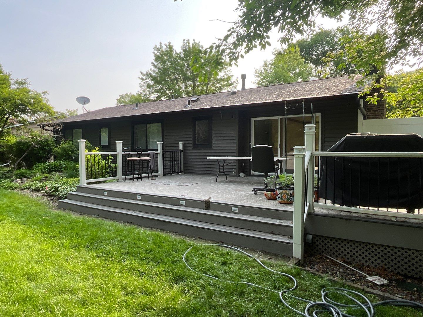Premium Exterior Remodel – Alside Charter Oak Siding, Hayfield Black Frame Windows, Edco Soffit & Fascia by First Impressions Exteriors