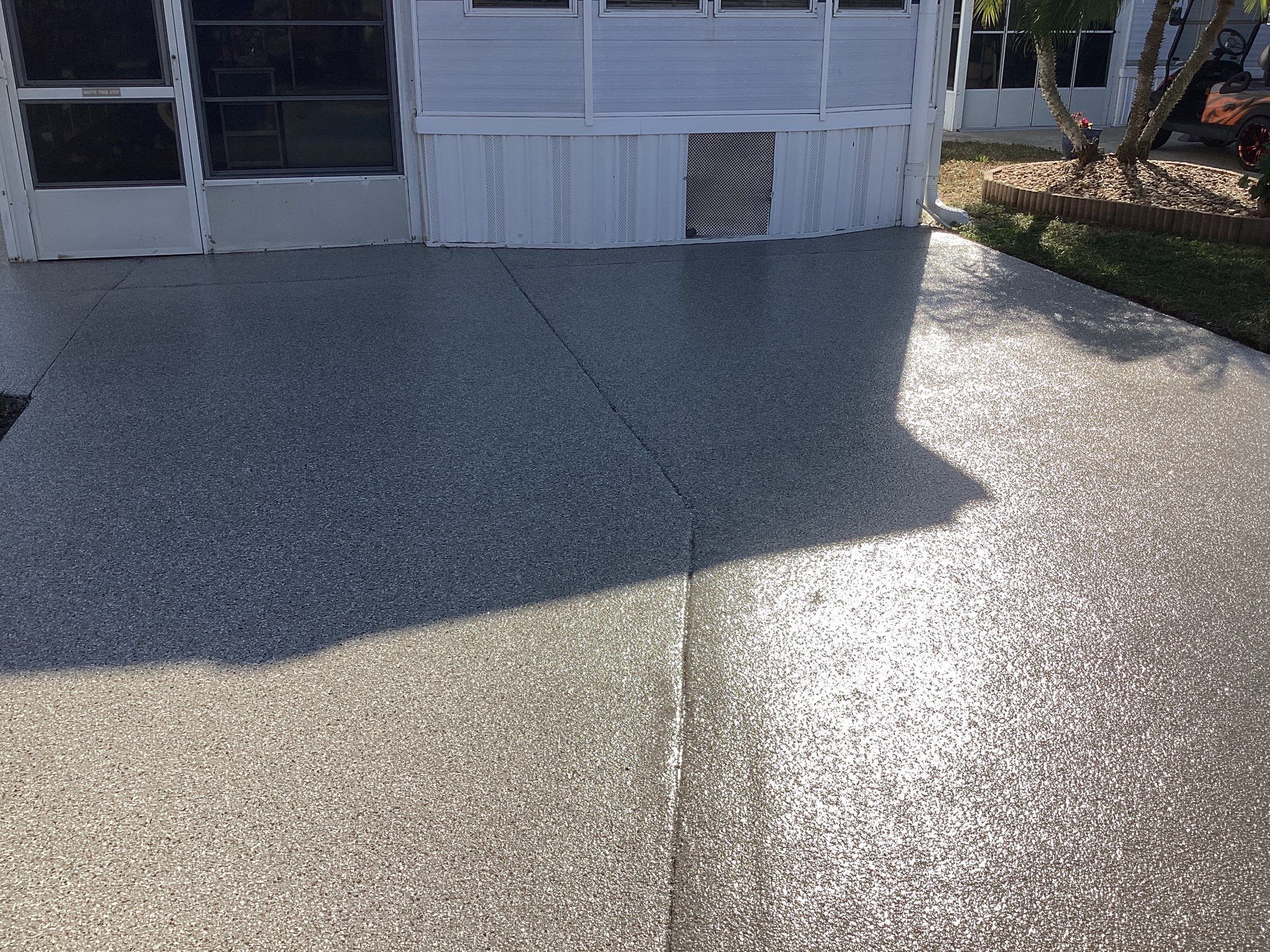 Driveway using Pebble Beach by Amvet concrete coatings llc