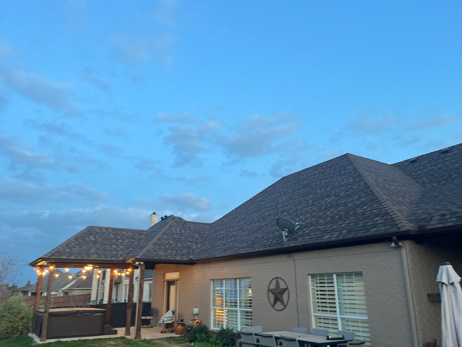 Cream brick/mixed stone with IKO Shadow Brown by Tejas Roofworks + Restoration