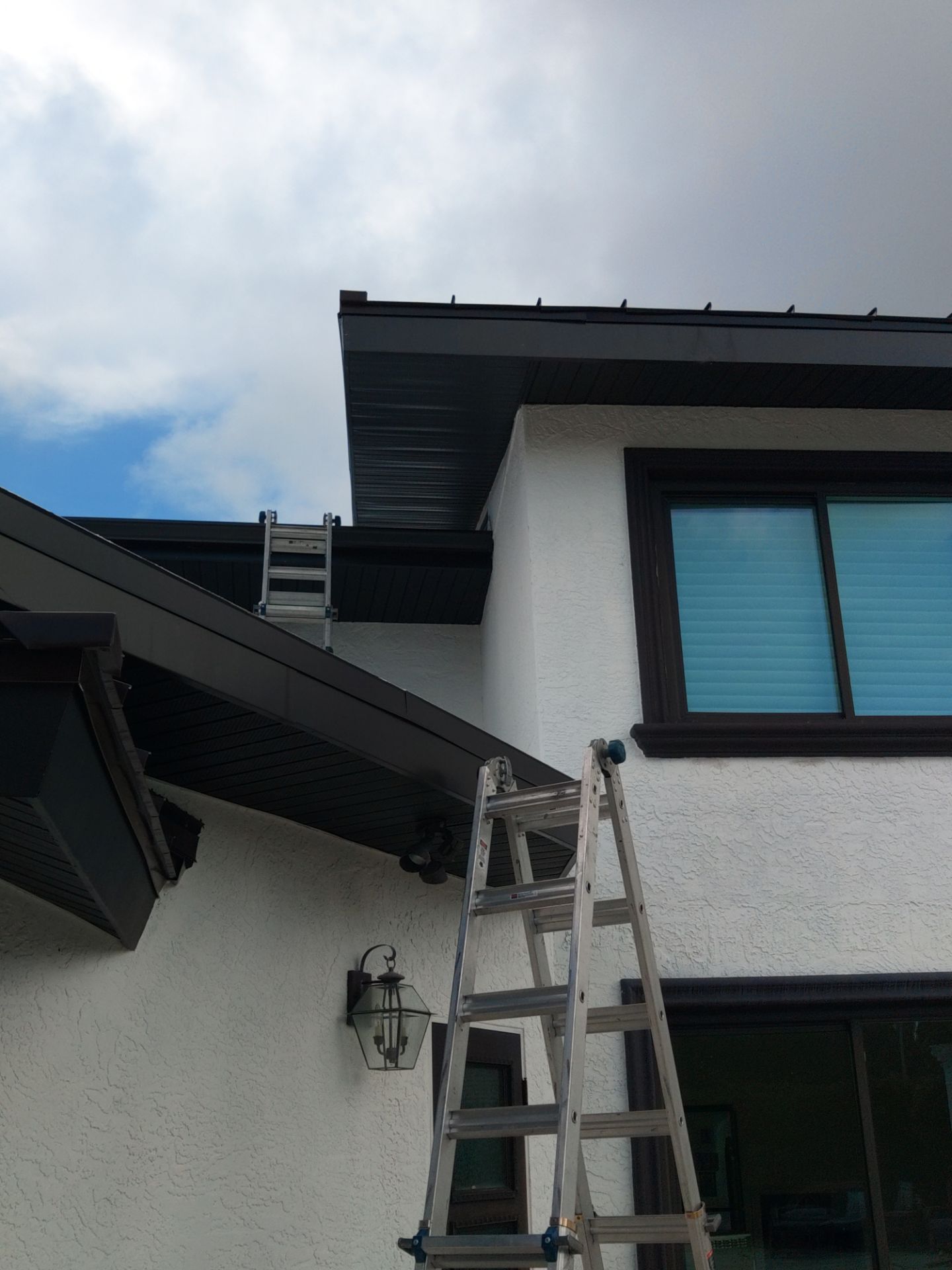 Black Seamless Gutters and Downspouts in Siesta Key FL by Gutter Professors