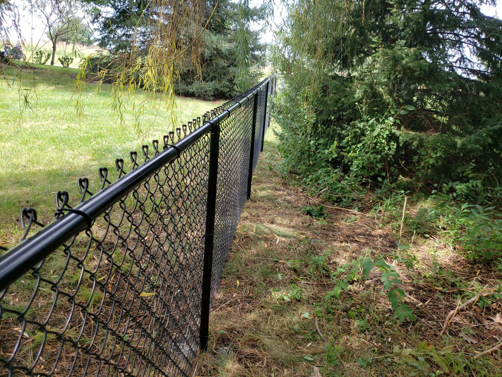 Black Vinyl-Coated Chain Link Fence Installation in Cedar Falls by Perfect Picket Fence and Stain