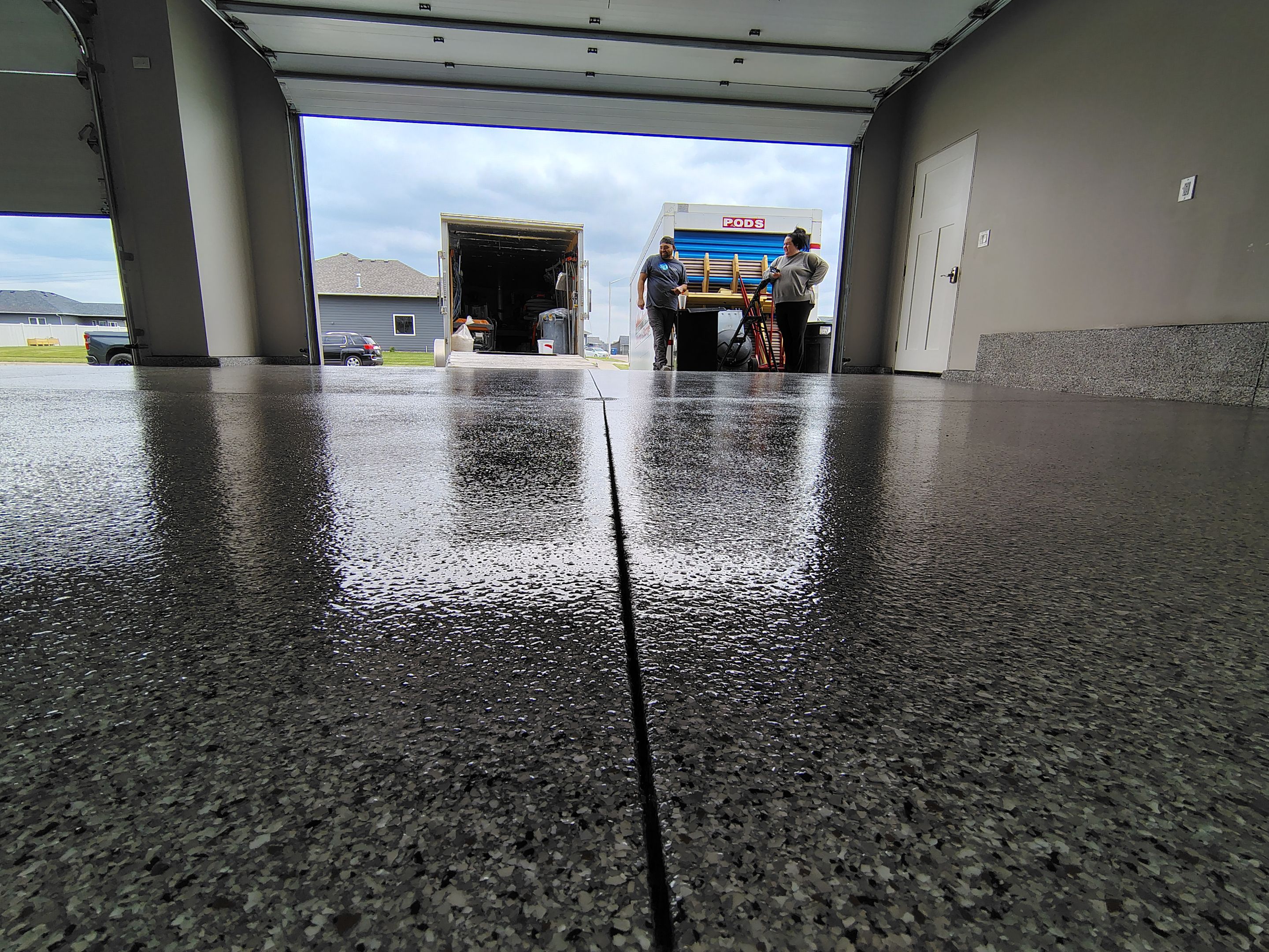 Grey Speckled Epoxy Garage Floor Coating in Sioux Falls by Select Painting, Coatings & Garage Cabinets