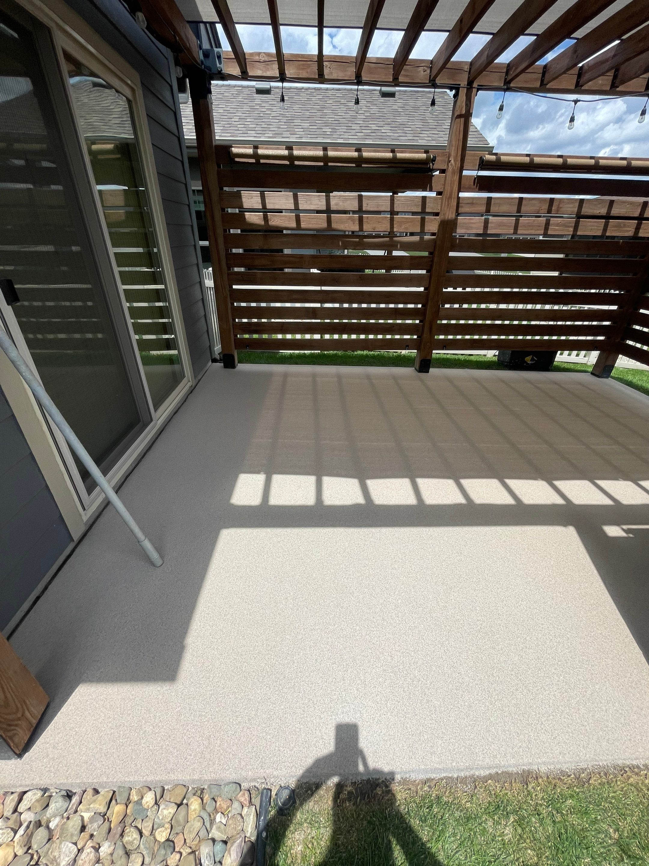 Textured Concrete Patio Coating and Custom Privacy Pergola in Sioux Falls by Select Painting, Coatings & Garage Cabinets