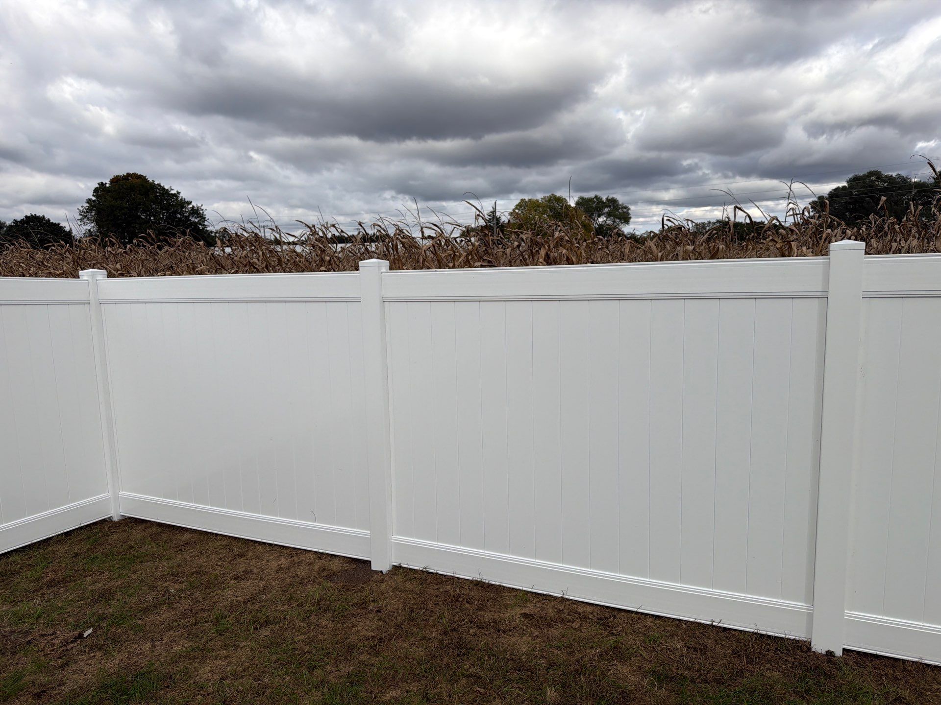 Residential White Vinyl Privacy Fence Installation in Janesville by Perfect Picket Fence and Stain