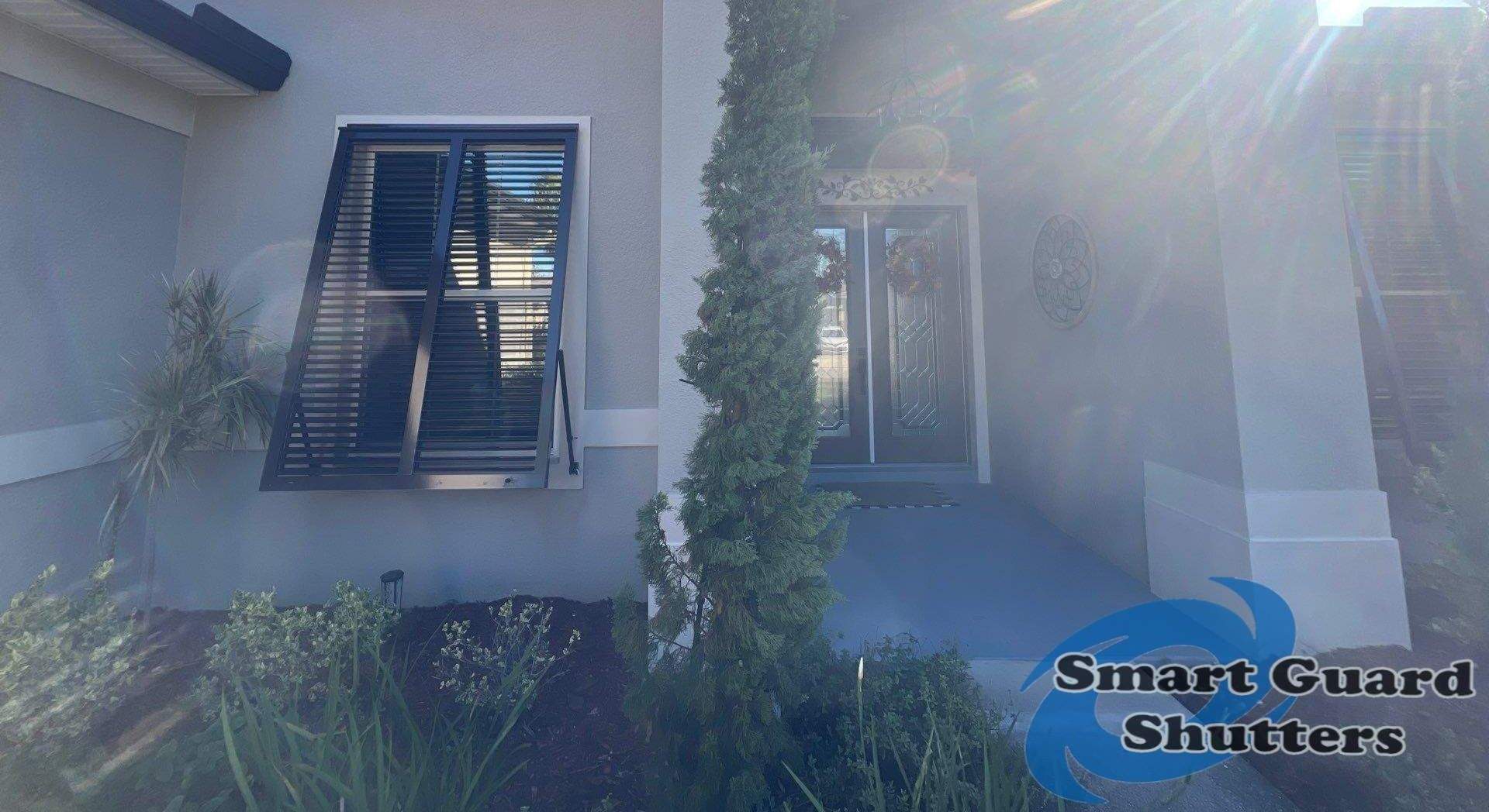 Impact Bahama Shutters in Grey Brown by Smart Guard Shutters