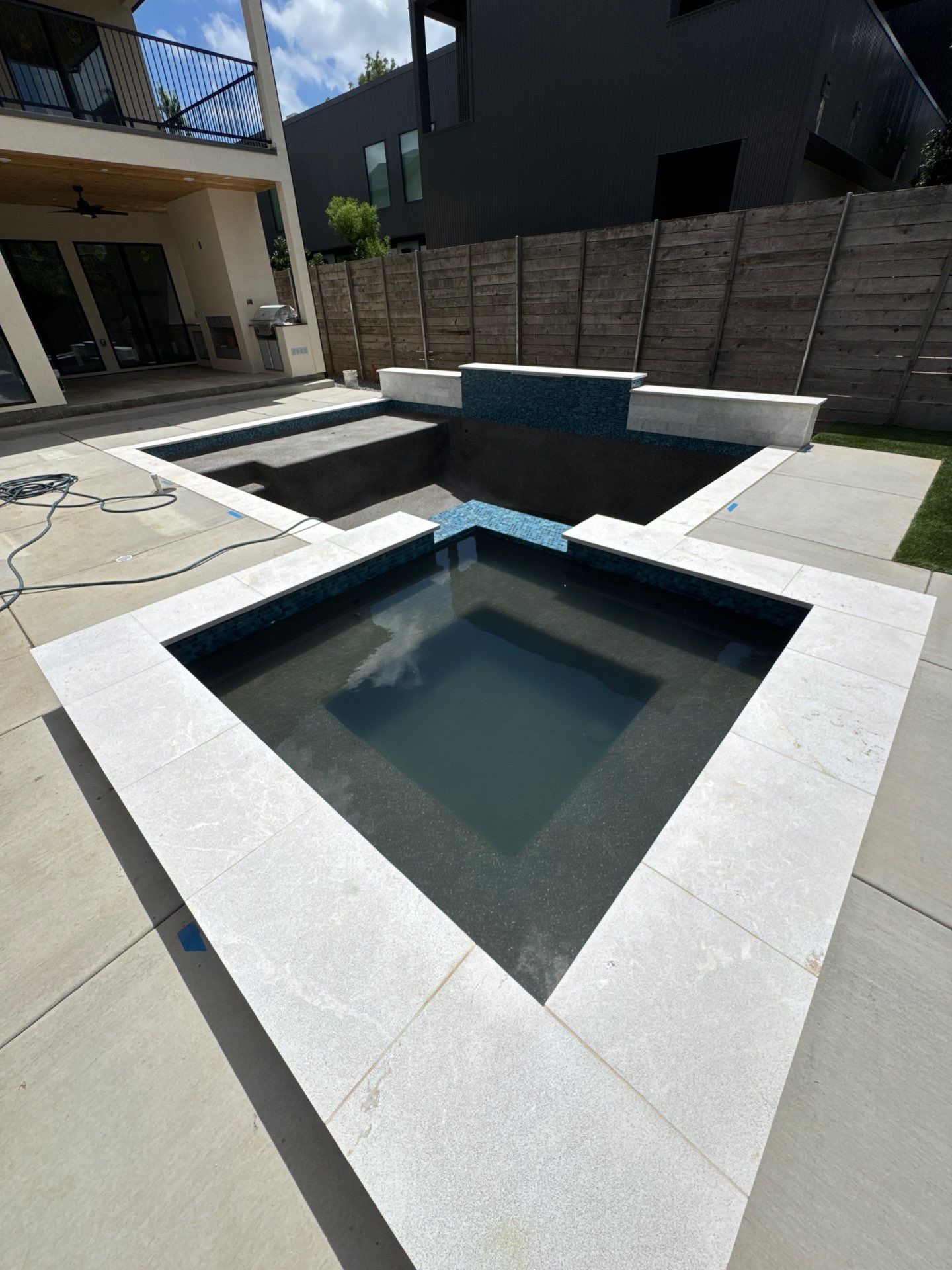 Modern Pool with Raised Glass-Tile Spa by Pinnacle Pools and Spas - DFW