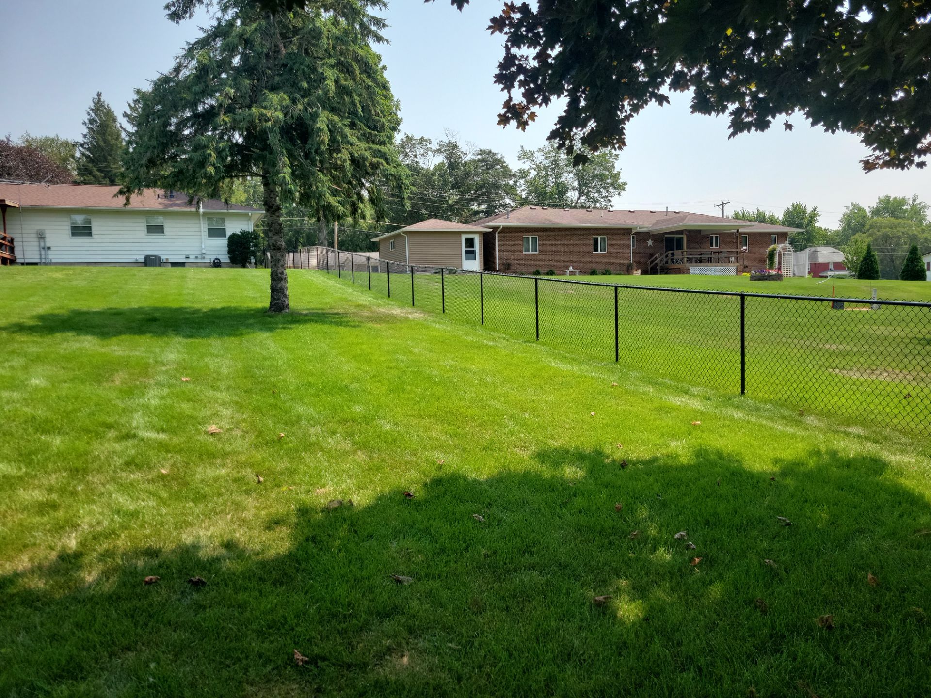 Black Vinyl-Coated Chain Link Fence Installation in New Hampton by Perfect Picket Fence and Stain