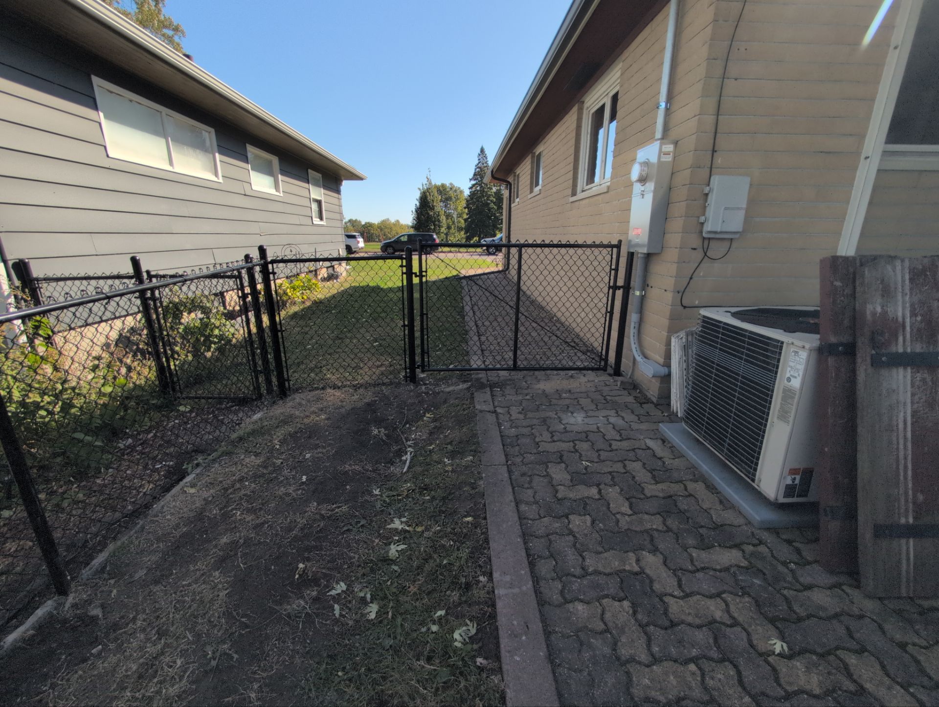 Black Chain Link Fence Installation for Waterloo Residential Property by Perfect Picket Fence and Stain