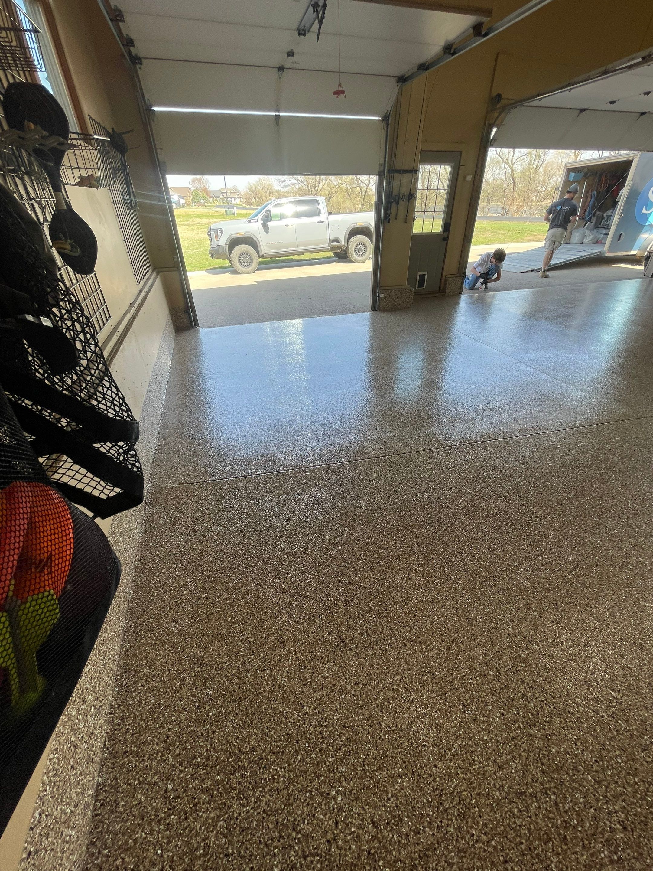 Residential Garage Floor Transformation with Speckled Epoxy Coating by Select Painting, Coatings & Garage Cabinets