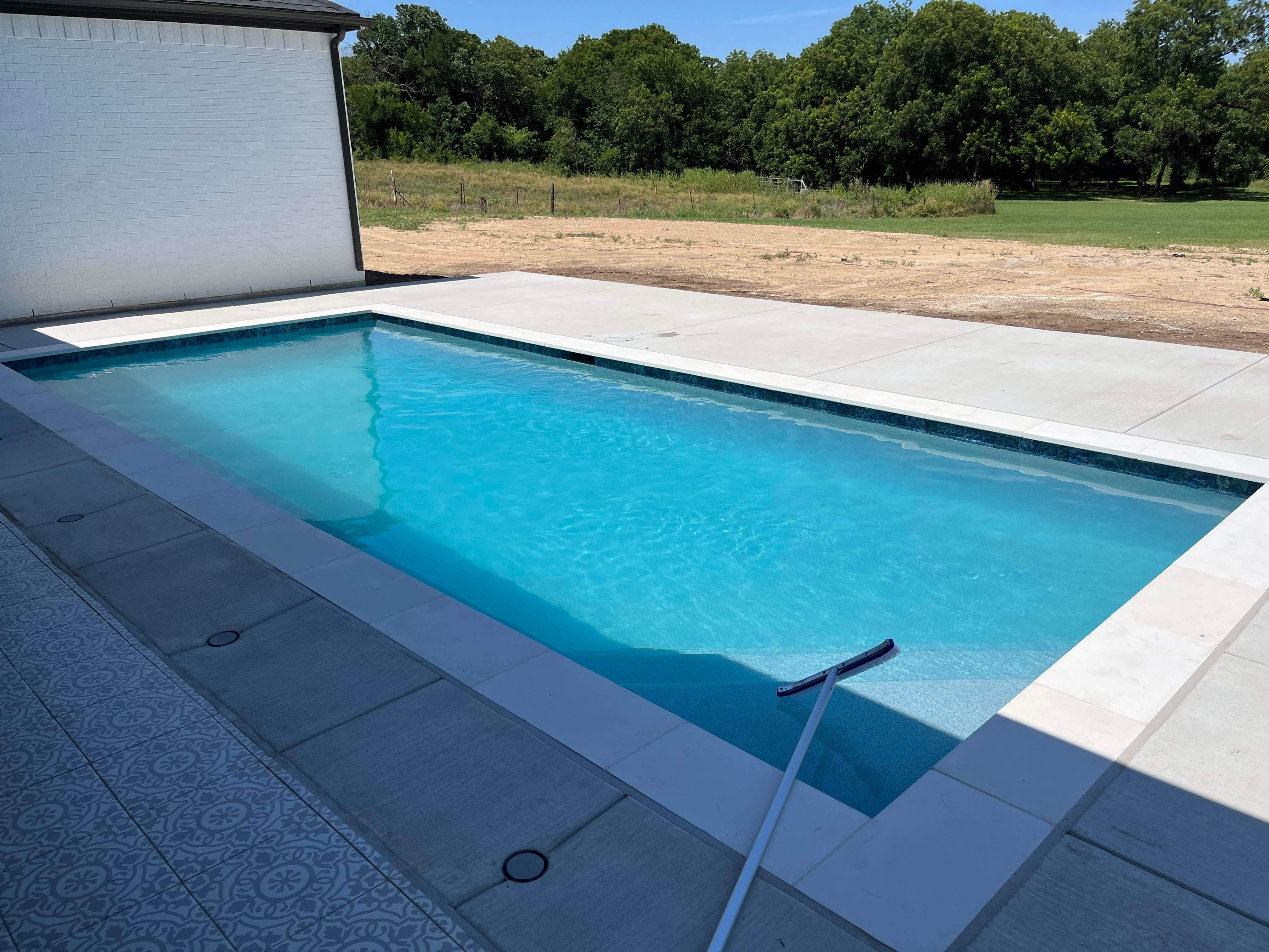 Geometric Pool with Tanning Ledge by Pinnacle Pools and Spas - DFW
