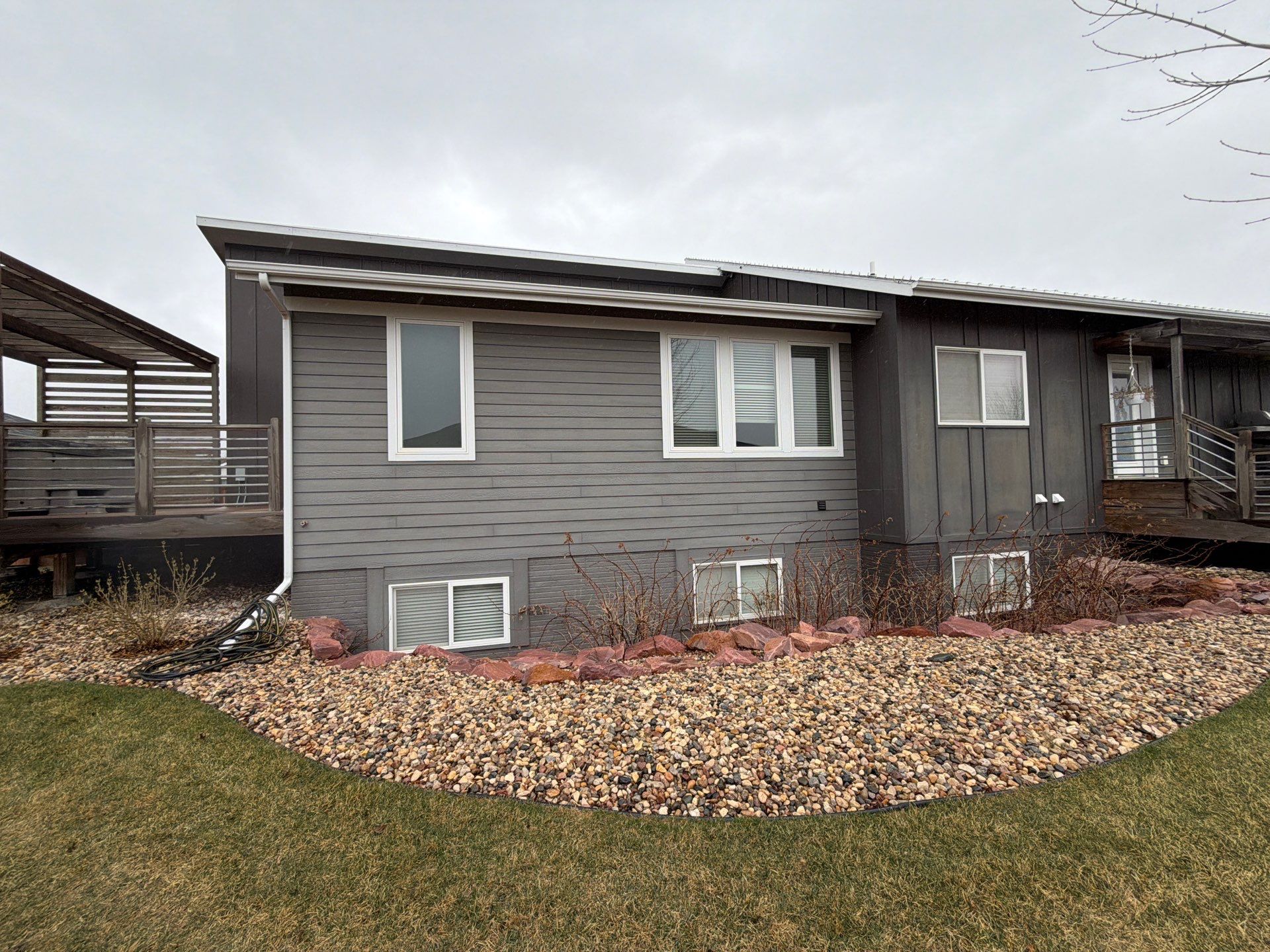 Modern Exterior Transformation Featuring Dark Board and Batten Siding in Sioux Falls by Select Painting, Coatings & Garage Cabinets